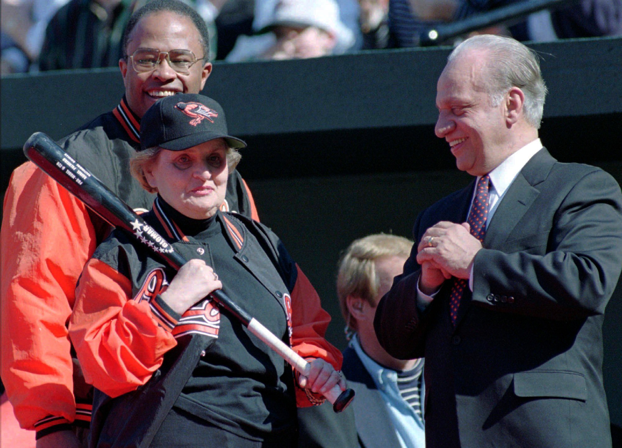 FILE -Secretary of State Madeleine Albright clutches a bat as she stands with Baltimore Orioles owner Peter Angelos, right, and Baltimore Mayor Kurt Schmoke on the field at Camden Yards in Baltimore Wednesday, April 2, 1997, during season-opening ceremonies. Peter Angelos, owner of a Baltimore Orioles team that endured long losing stretches and shrewd proprietor of a law firm that won high-profile cases against industry titans, died Saturday, March 23, 2024. He was 94. (AP Photo/Nick Wass, File)
