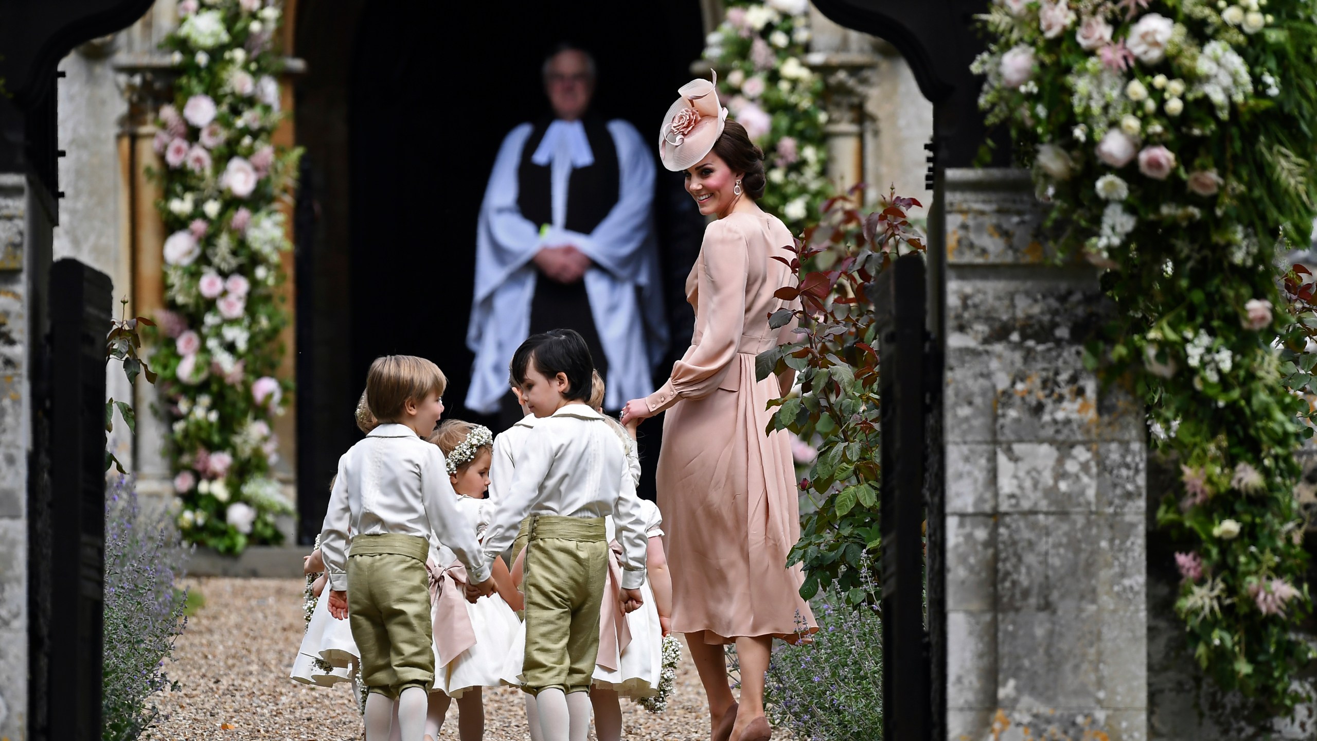 Britain's Catherine, Duchess of Cambridge, right, walks with the bridesmaids and pageboys as they arrive for her sister Pippa Middleton's wedding to James Matthews, at St Mark's Church in Englefield, England, Saturday, May 20, 2017. (Justin Tallis/Pool Photo via AP, File)