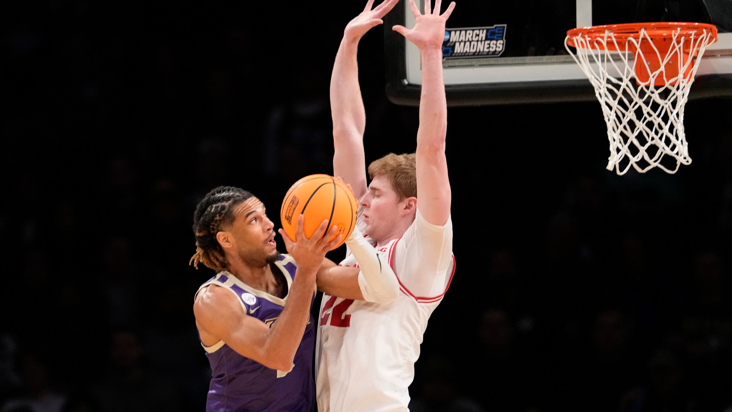 James Madison forward T.J. Bickerstaff, left, goes to the basket against Wisconsin forward Steven Crowl (22) during the first half of a first-round college basketball game in the men's NCAA Tournament, Friday, March 22, 2024, in New York. (AP Photo/Mary Altaffer)
