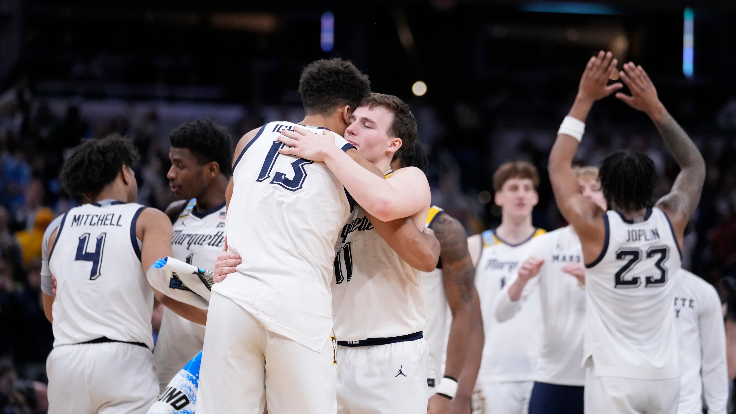Marquette's Tyler Kolek (11) and Oso Ighodaro (13) celebrates with teammates following a second-round college basketball game against Colorado in the NCAA Tournament, Sunday, March 24, 2024 in Indianapolis. Marquette won 81-77. (AP Photo/Michael Conroy)