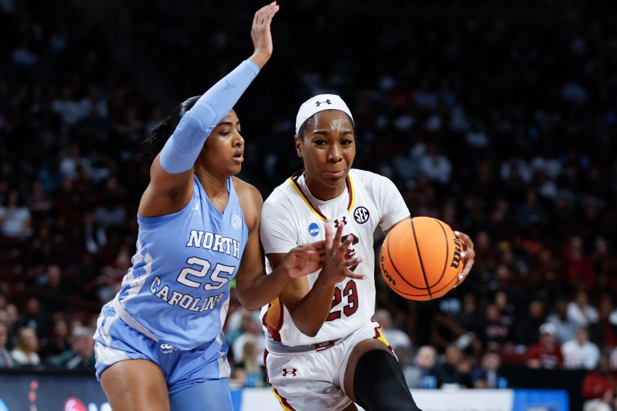 South Carolina guard Bree Hall, right, drives against North Carolina guard Deja Kelly, left, during the first half of a second-round college basketball game in the women's NCAA Tournament in Columbia, S.C., Sunday, March 24, 2024. (AP Photo/Nell Redmond)