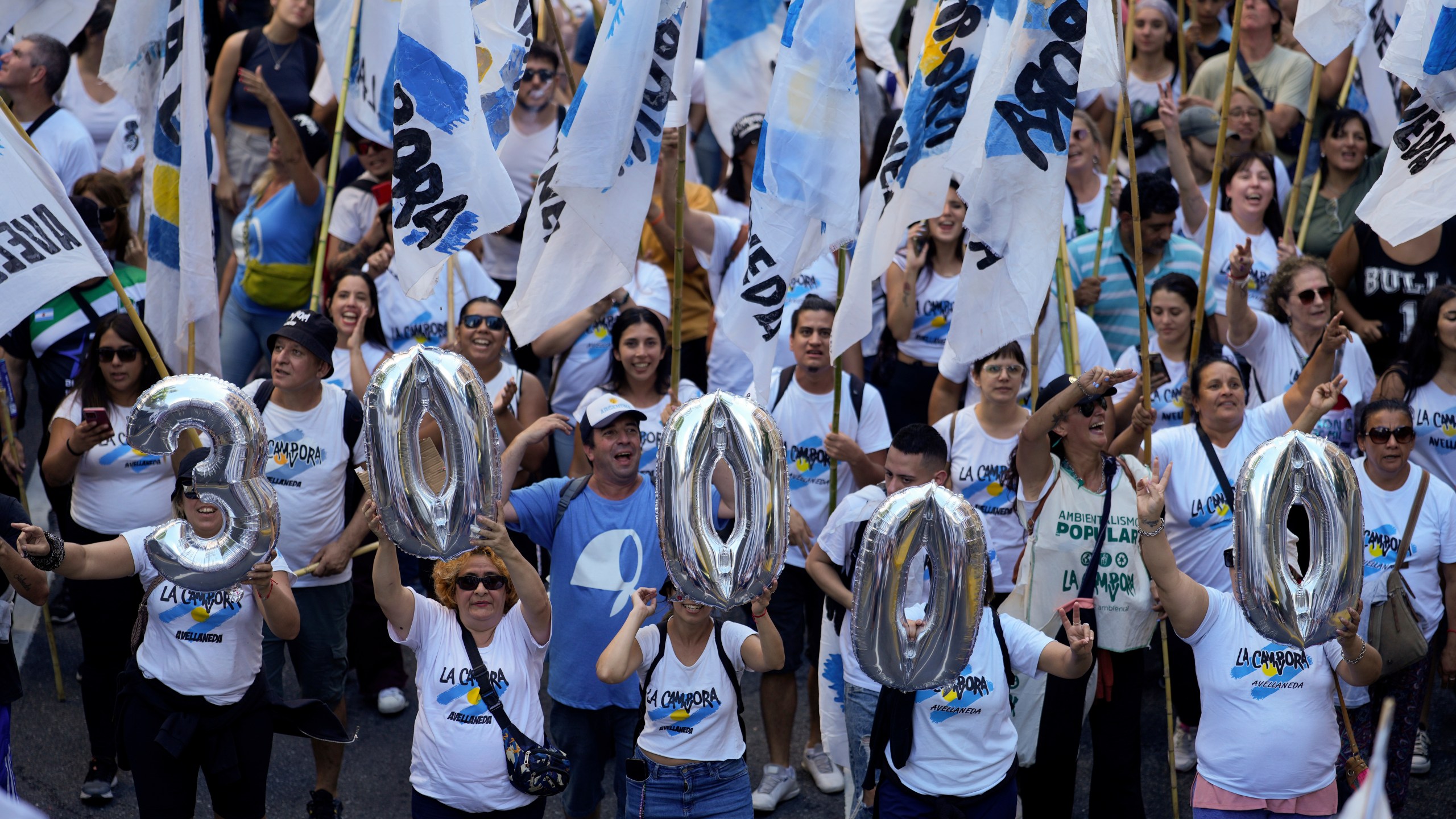 Demonstrators carry inflatables shaped like the number 30,000, referring to the number of people who, according to human rights groups, disappeared during the 1976-1983 military dictatorship, during a march commemorating the 48th anniversary of the coup in Buenos Aires, Argentina, Sunday, March 24, 2024. (AP Photo/Natacha Pisarenko)