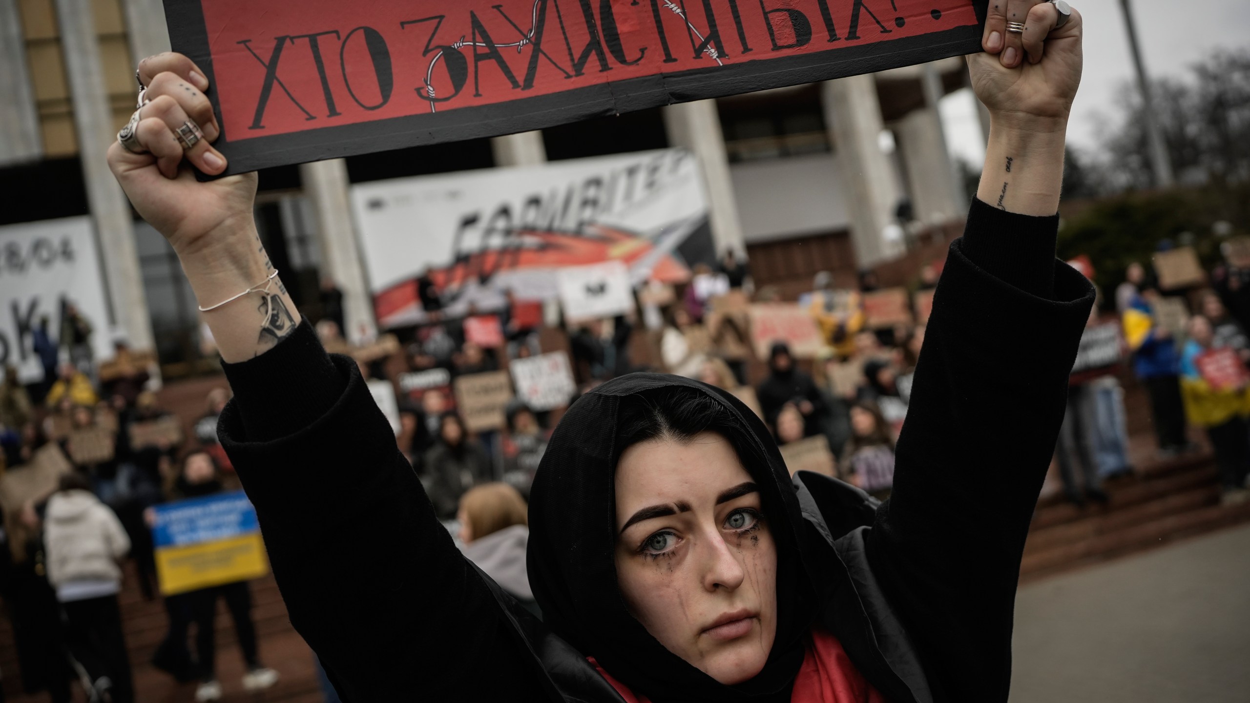 A woman holds a sign during a protest in Kyiv, Ukraine, Sunday March 24, 2024, to demand the freedom of Ukrainian Mariupol's Azovstal defenders still being held prisoners by Russia. (AP Photo/Enric Marti)