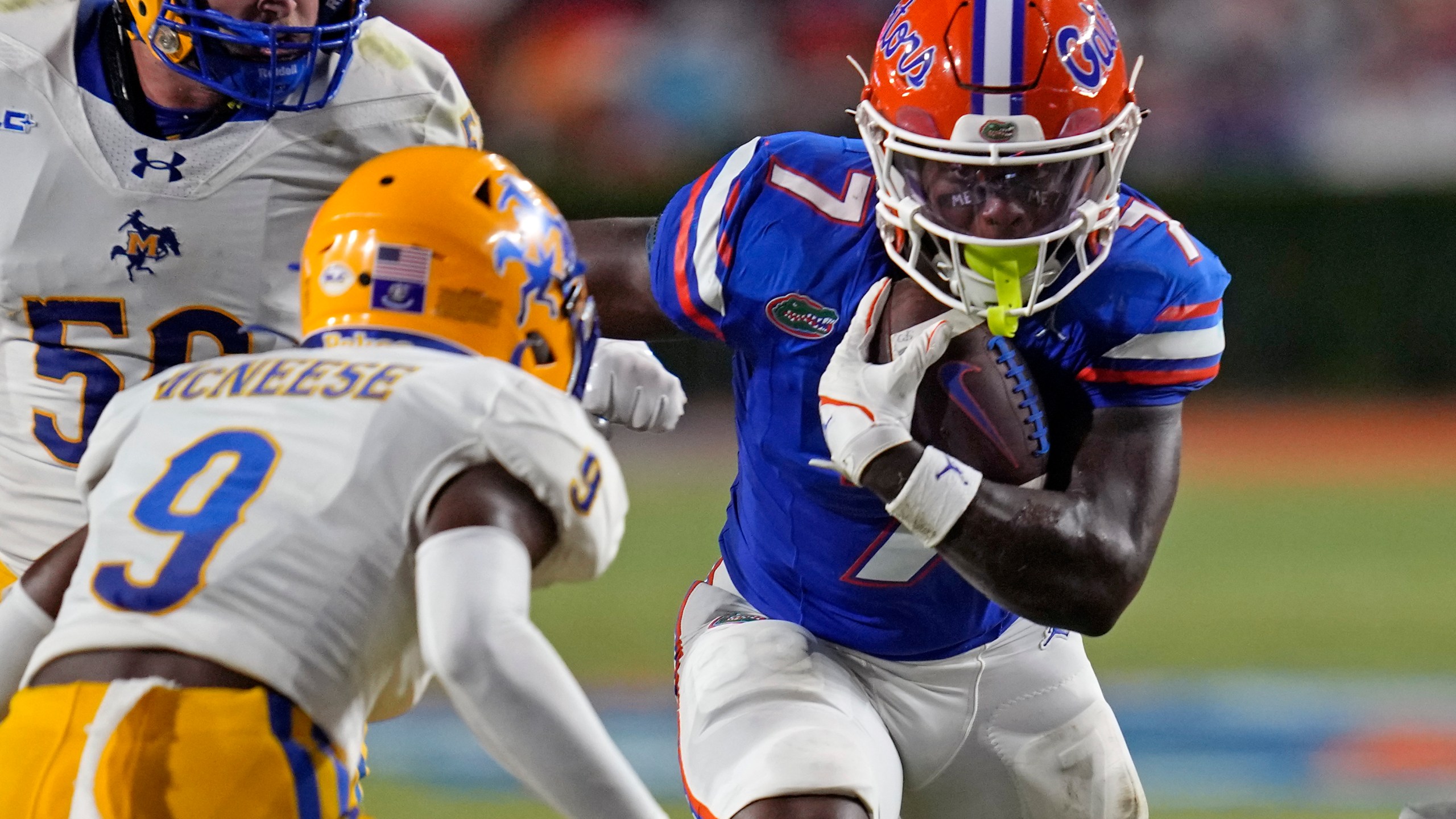 FILE - Florida running back Trevor Etienne, right, tries to get past McNeese State defensive back Jadden Matthews (9) during the first half of an NCAA college football game, Saturday, Sept. 9, 2023, in Gainesville, Fla. Georgia running back Trevor Etienne was arrested early Sunday, March 24, 2024, on drunken driving, reckless driving and other charges, jail records show. Etienne is a midyear transfer from Florida, where he led the Gators with nine touchdowns in 2023 and emerged as one of the team’s most dynamic playmakers. (AP Photo/John Raoux, File)