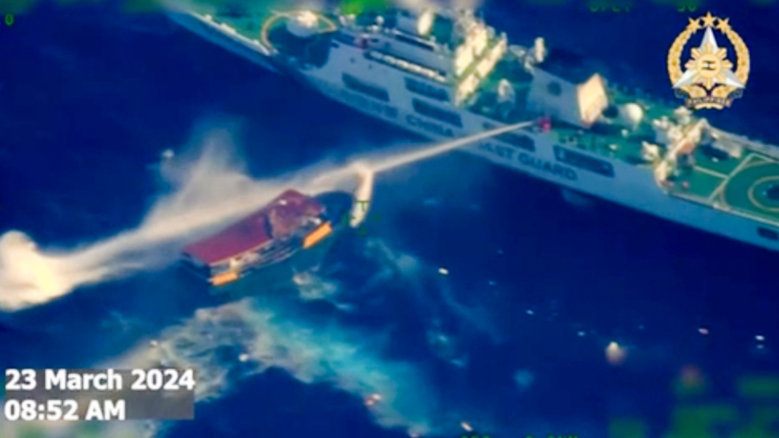 In this screen grab from video provided by the Armed Forces of the Philippines, a Chinese coast guard ship uses water cannons on a Philippine resupply vessel Unaizah May 4 as it approaches Second Thomas Shoal, locally called Ayungin shoal, at the disputed South China Sea on Saturday, March 23, 2024. (Armed Forces of the Philippines via AP)