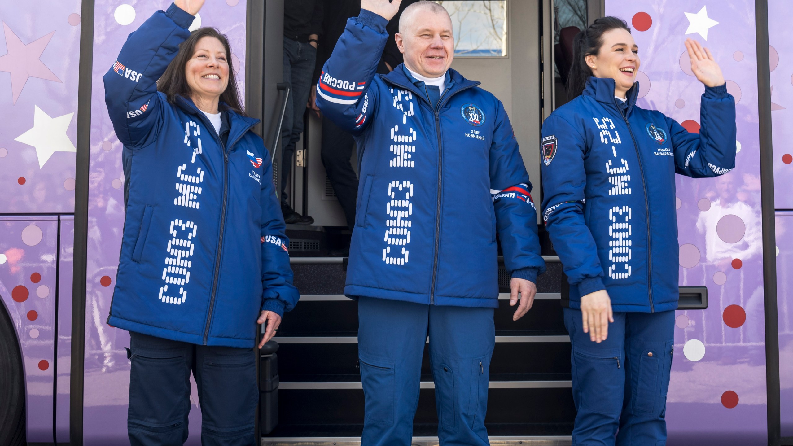 Expedition 71 NASA astronaut Tracy Dyson, from left, Roscosmos cosmonaut Oleg Novitskiy, and Belarus spaceflight participant Marina Vasilevskaya wave as they depart the Cosmonaut Hotel in Baikonur, Kazakhstan, Saturday, March 23, 2024, to suit up for their Soyuz launch to the International Space Station. Russia’s Roscosmos space agency has aborted the launch of three astronauts to the International Space Station about 20 seconds before they were scheduled to lift off. Russia's Roscosmos space corporation said the next launch attempt is set for Saturday. (Bill Ingalls/NASA via AP)