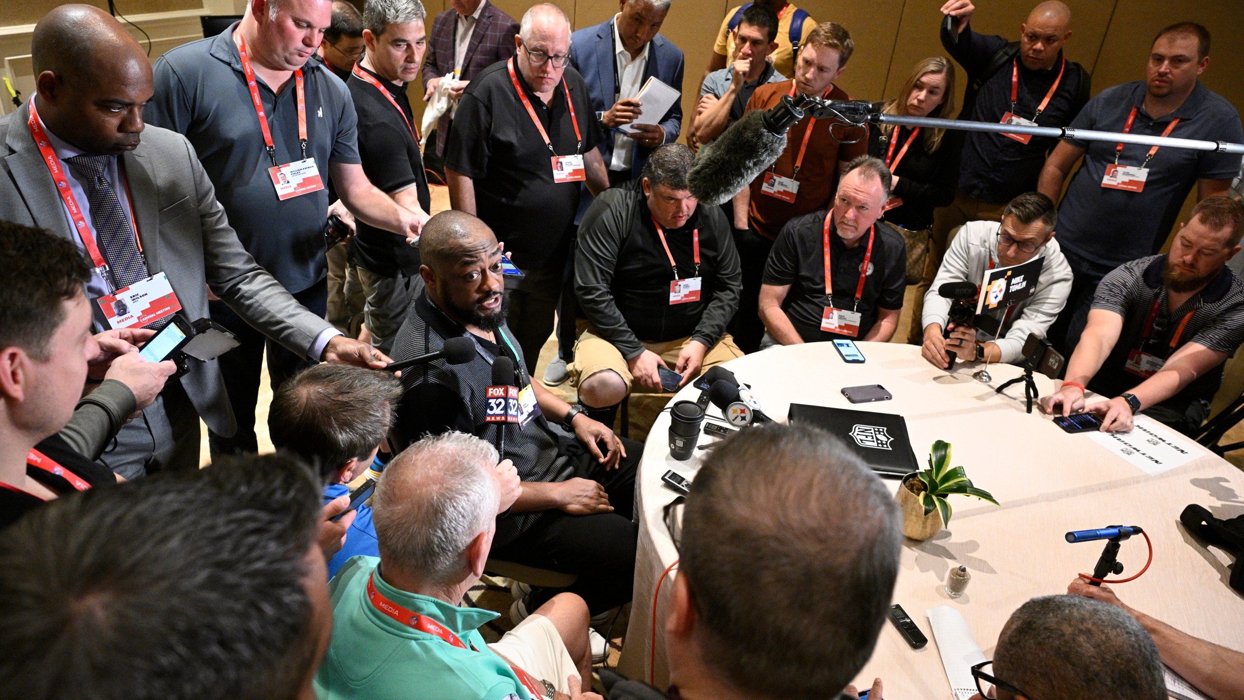 Pittsburgh Steelers head coach Mike Tomlin, center, talks with reporters during an AFC coaches availability at the NFL owners meetings, Monday, March 25, 2024, in Orlando, Fla. (AP Photo/Phelan M. Ebenhack)