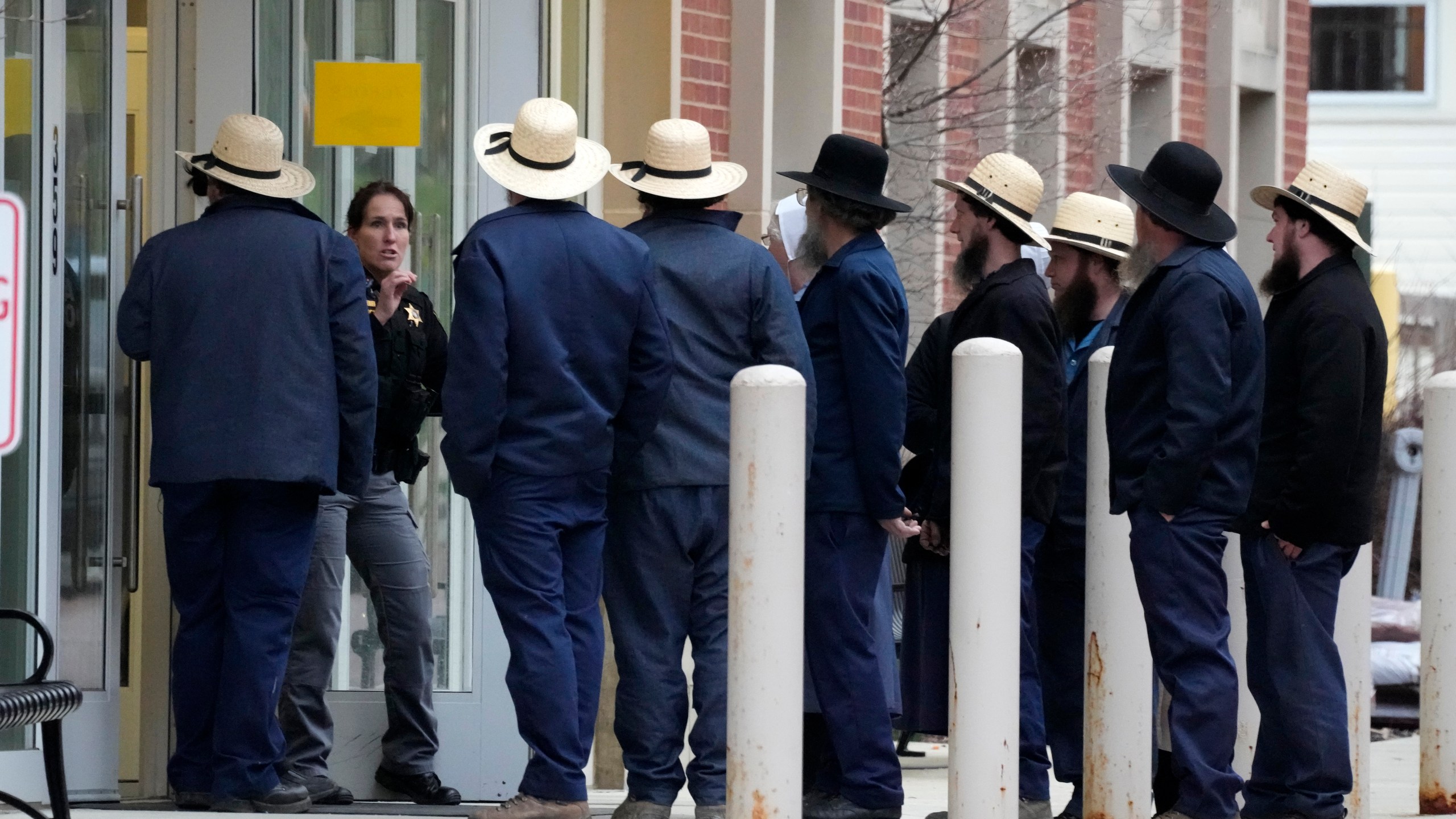 FILE - A group of Amish gather outside the Crawford County Judicial Center in Meadville, Pa., following a preliminary hearing, March 15, 2024, for Shawn C. Cranston, 52, of Corry, Pa., who is accused of killing Rebekah Byler and her unborn child inside the Byler home near Spartansburg, Pa., on Feb. 26. Six guns, a variety of ammunition and a pair of sneakers that may match tread marks left at the murder scene were seized during searches of the home and vehicle of a man accused of killing the pregnant Amish woman in her rural Pennsylvania home a month ago. (AP Photo/Gene J. Puskar, file)