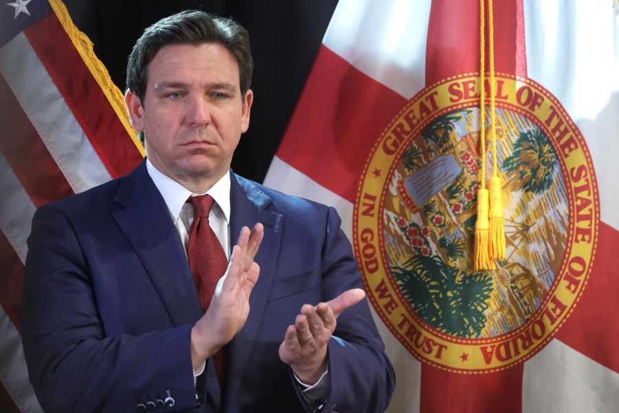 FILE 0 Florida Gov. Ron DeSantis applauds during a press conference at the Central Florida Tourism Oversight District headquarters at Walt Disney World, in Lake Buena Vista, Fla., Thursday, Feb. 22, 2024. Florida will have one of the country's most restrictive social media bans for minors — if it withstands expected legal challenges — under a bill signed by Republican Florida Gov. Ron DeSantis on Monday, March 25, 2024. (Joe Burbank/Orlando Sentinel via AP, File)