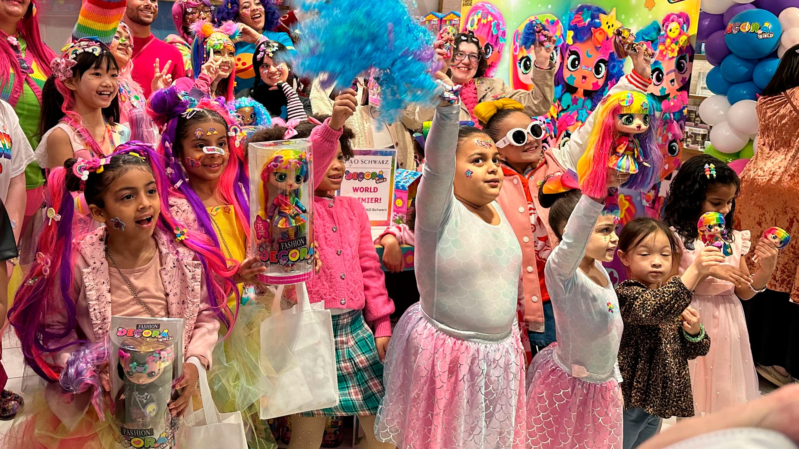 Some of the 30 child influencers invited by toy company Cepia LLC wave at an event held to launch its new fashion doll line called Decora Girlz, at an FAO Schwarz store on March 2, 2024 in New York. Cepia began investing in TikTok in 2019. (AP Photo/Anne D'Innocenzio)