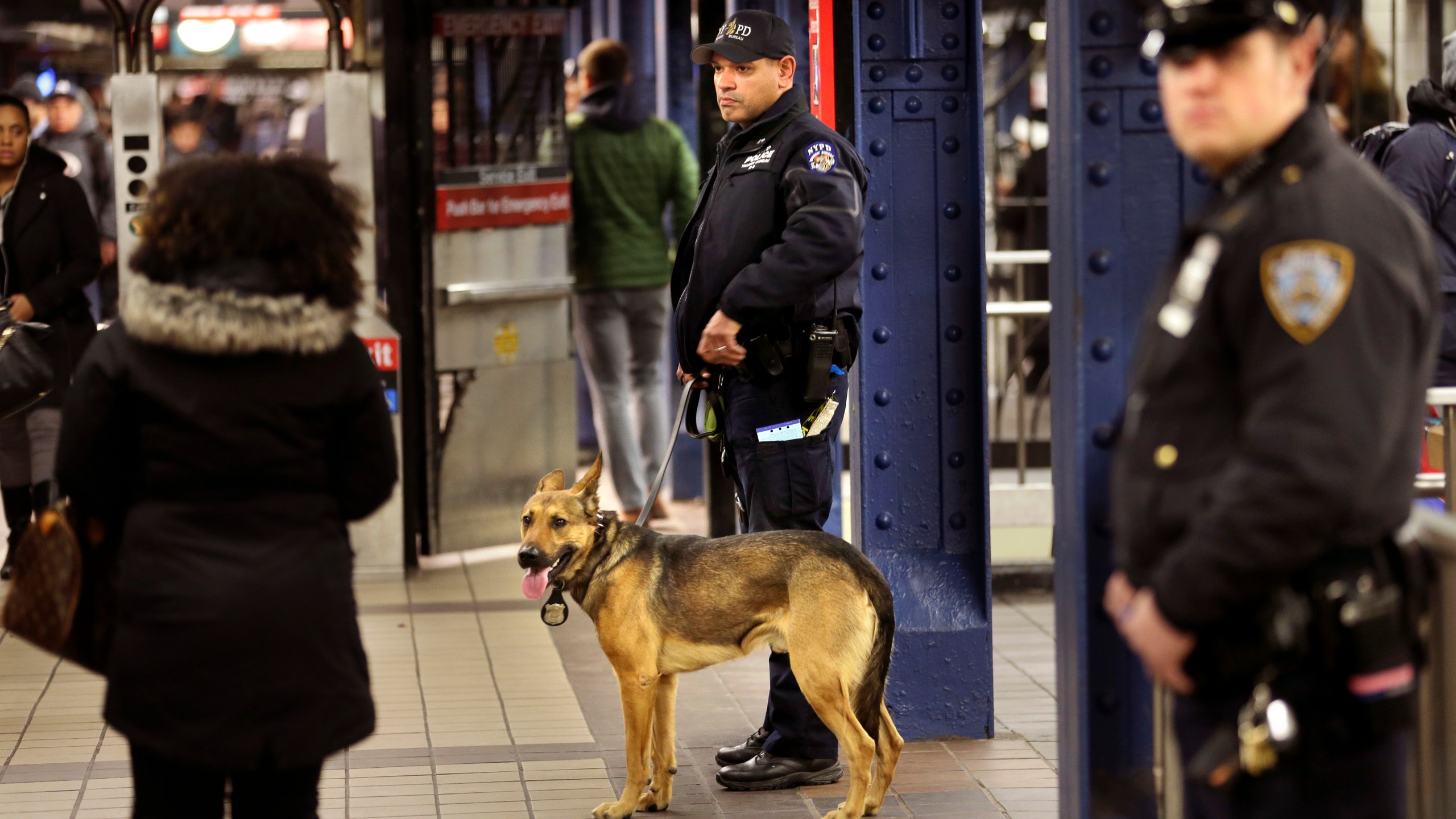 FILE - Police officers patrol in the passageway connecting New York City's Port Authority bus terminal and the Times Square subway station, Dec. 12, 2017. New York City plans to intensify a crackdown on subway fare-beating by sending at least 800 police officers specifically to keep watch on turnstiles, officials announced Monday, March 25, 2024. (AP Photo/Seth Wenig, File)
