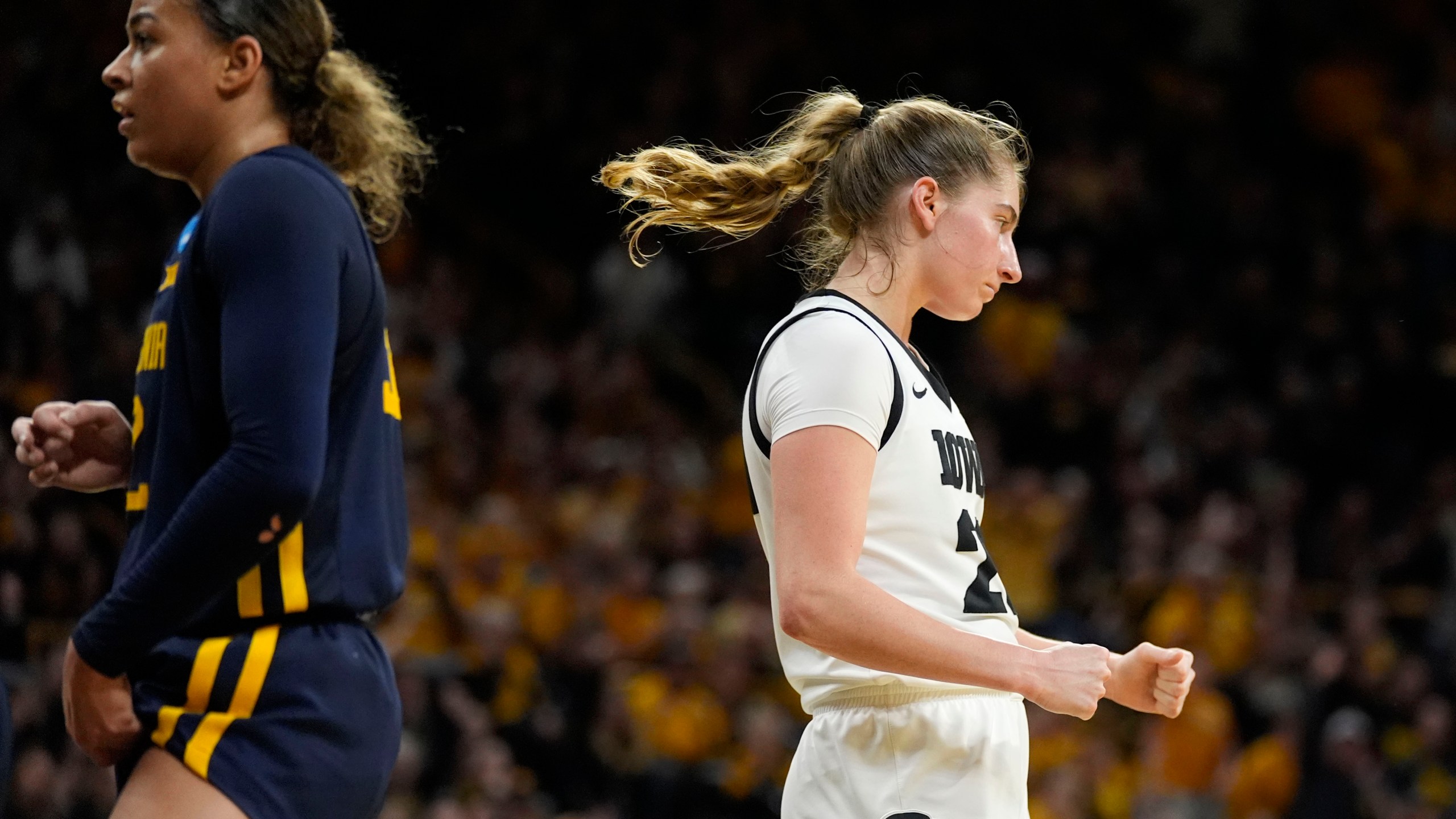 Iowa guard Kate Martin, right, reacts after making a basket in the second half of a second-round college basketball game against West Virginia in the NCAA Tournament, Monday, March 25, 2024, in Iowa City, Iowa. (AP Photo/Charlie Neibergall)