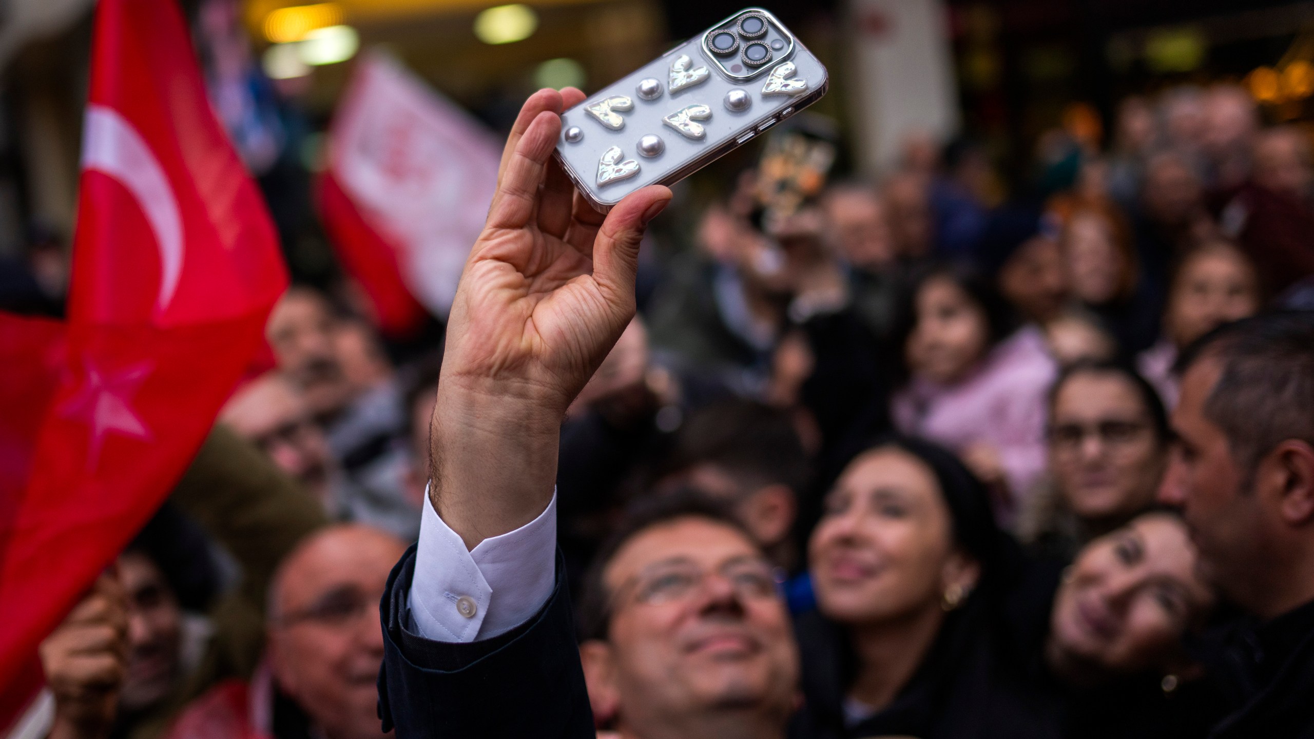 Istanbul Mayor and Republican People's Party, or CHP, candidate for Istanbul Ekrem Imamoglu, center, takes a photograph with supporters during a campaign rally, in Istanbul, Turkey, Tuesday, March 19, 2024. On Sunday, millions of voters in Turkey head to the polls to elect mayors and administrators in local elections which will gauge President Recep Tayyip Erdogan’s popularity as his ruling party tries to win back key cities it lost five years ago. (AP Photo/Francisco Seco)