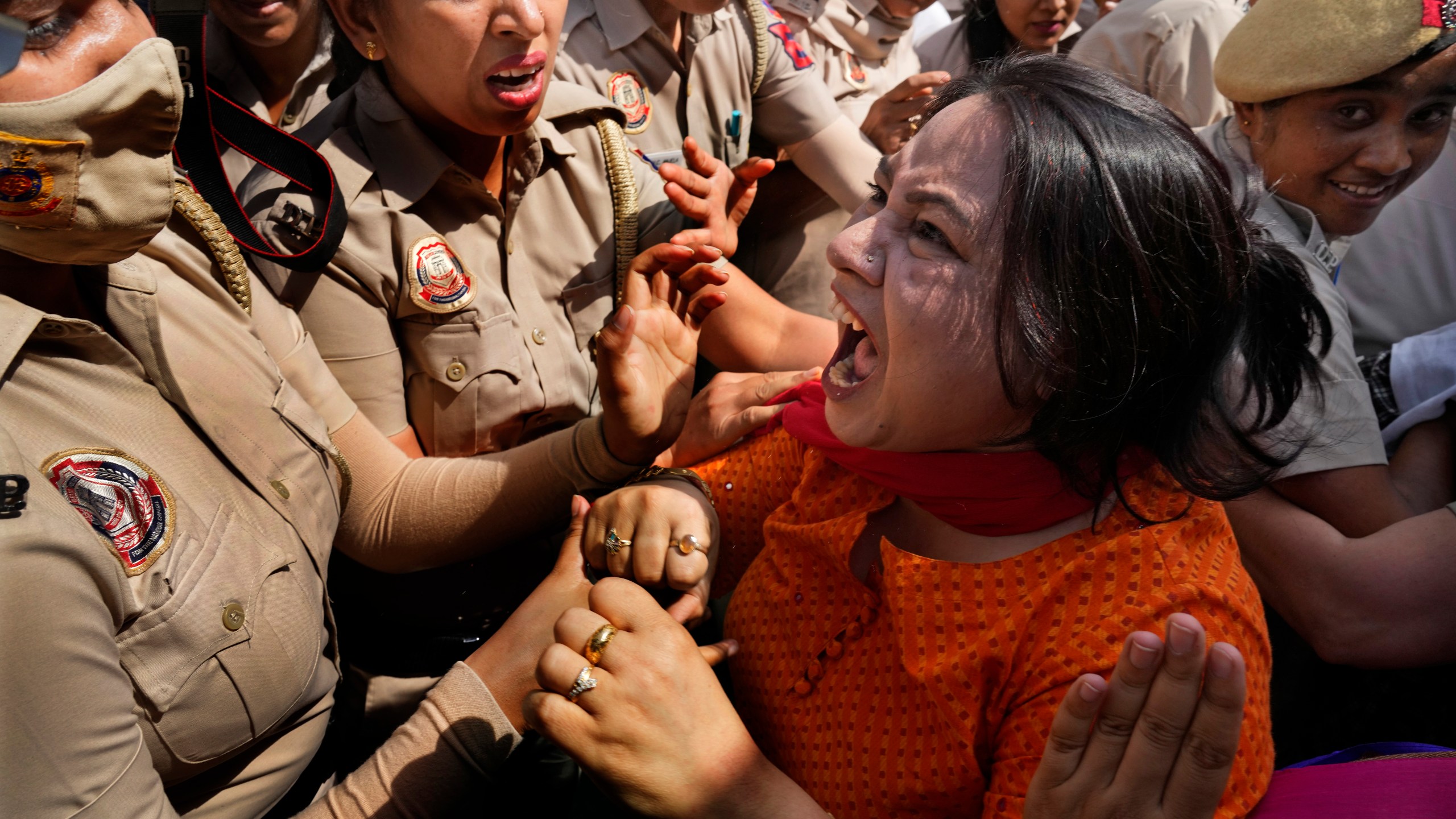A member of Aam Admi Party, or Common Man's Party, screams as she is detained by the police during a protest against the arrest of their party leader Arvind Kejriwal in New Delhi, India, Tuesday, March 26, 2024. Indian police have detained dozens of opposition protesters and prevented them from marching to Prime Minister Narendra Modi’s residence to demand the release of their leader and top elected official of New Delhi who was arrested last week in a liquor bribery case. (AP Photo/Manish Swarup)