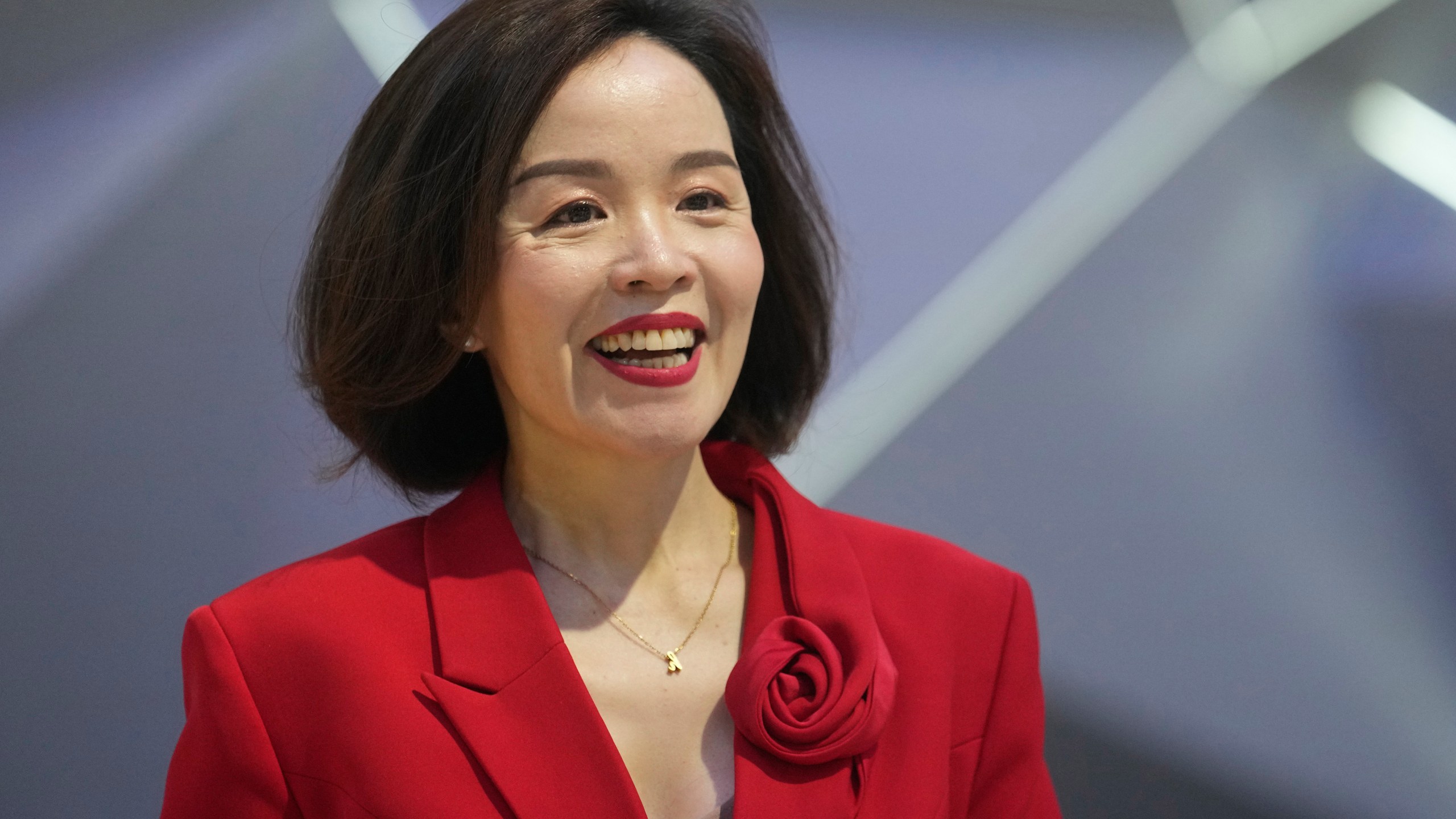 Vu Dang Yen Hang, chief executive officer of VinFast Thailand, smiles in front of its electric vehicle "VF7" during the 45th Bangkok Motor Show in Nonthaburi, Thailand, Tuesday, March 26, 2024. (AP Photo/Sakchai Lalit)