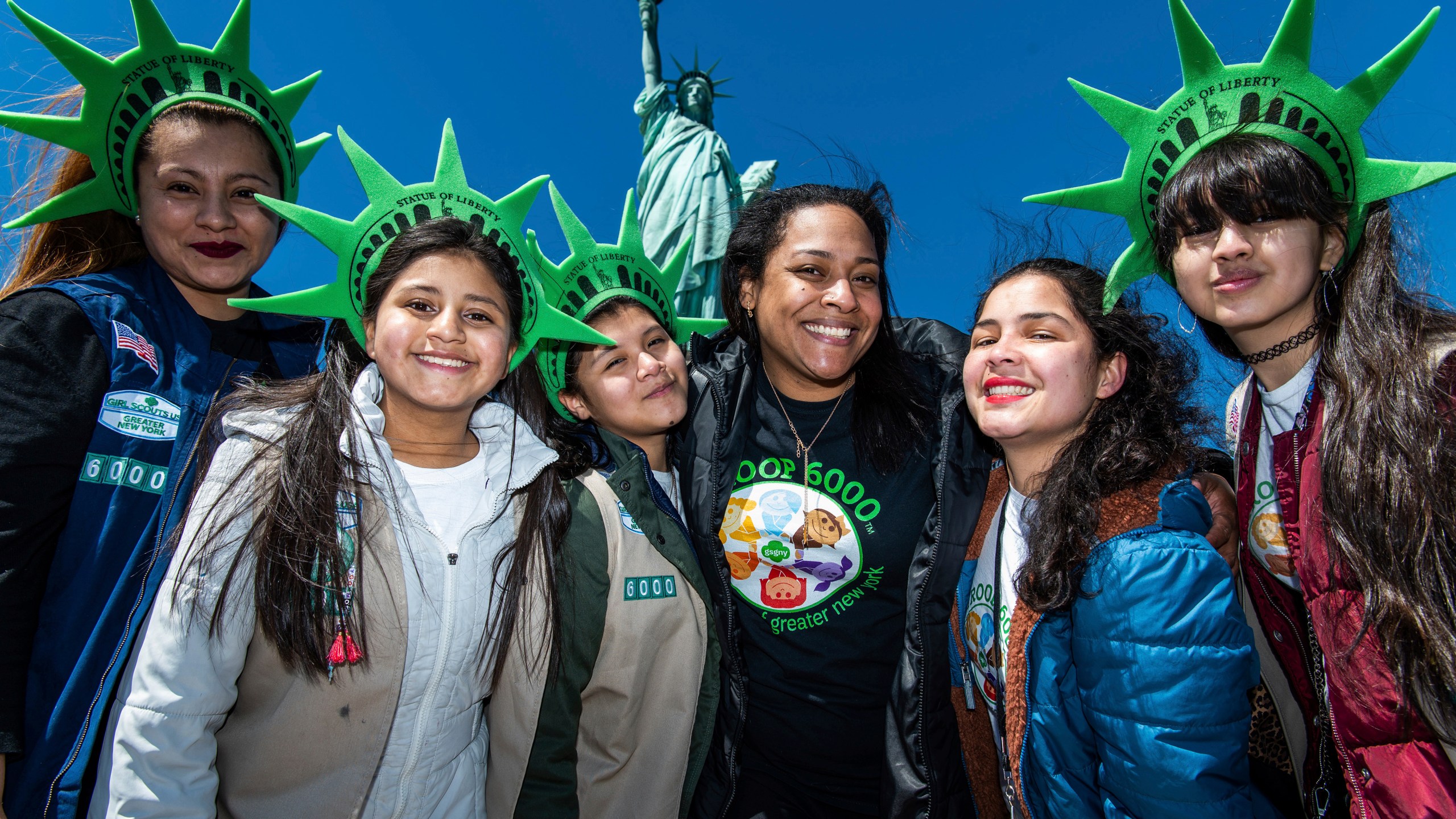 This photo provided by Girl Scouts of Greater New York shows Girl Scouts Troop 6000 paying a visit to the Statue of Liberty in New York in 2023. Troop 6000 has served kids who live in New York's shelter system since 2017, quietly welcoming hundreds of the city’s youngest new residents with the support of donations. (Kelly Marsh/Girl Scouts of Greater New York via AP)