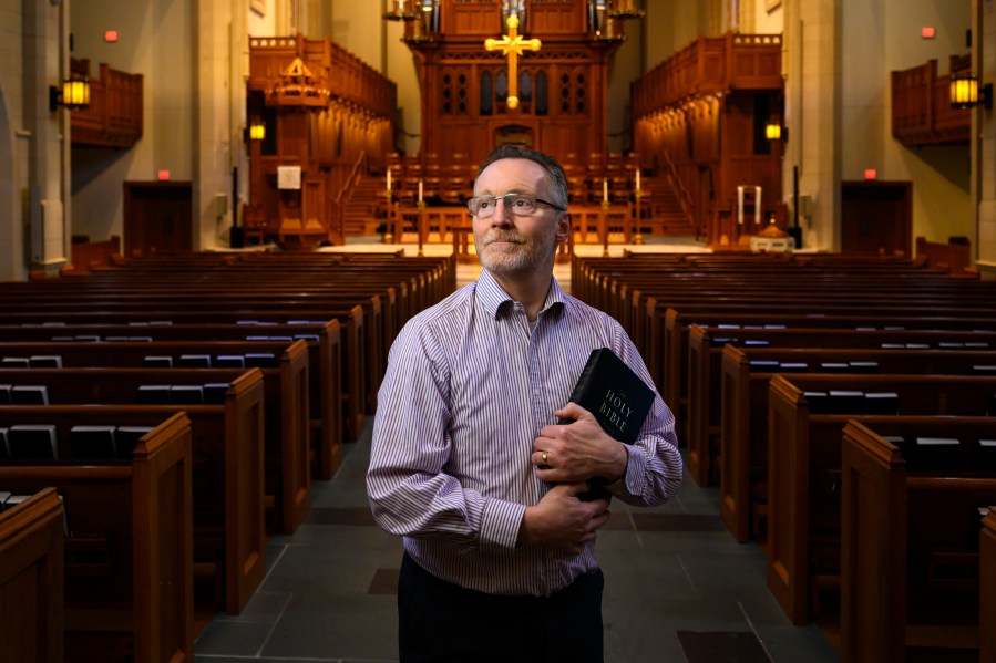 Chaplain of The Covenant School Matthew Sullivan stands in the school's church sanctuary where he lead chapel service in the past, Friday, March 22, 2024, in Nashville, Tenn. Facing the first anniversary of a tragic shooting which left six people dead, the school, which has been meeting in a temporary location, prepares to move back into the building where it happened. (AP Photo/John Amis)