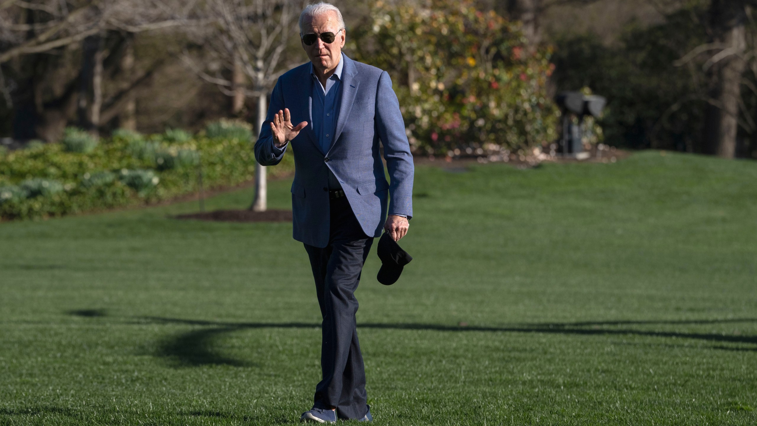 President Joe Biden waves to members of the media as he walks across the South Lawn of the White House after exiting the Marine One helicopter, Sunday, March 24, 2024, on return to Washington from Delaware. (AP Photo/Jacquelyn Martin)