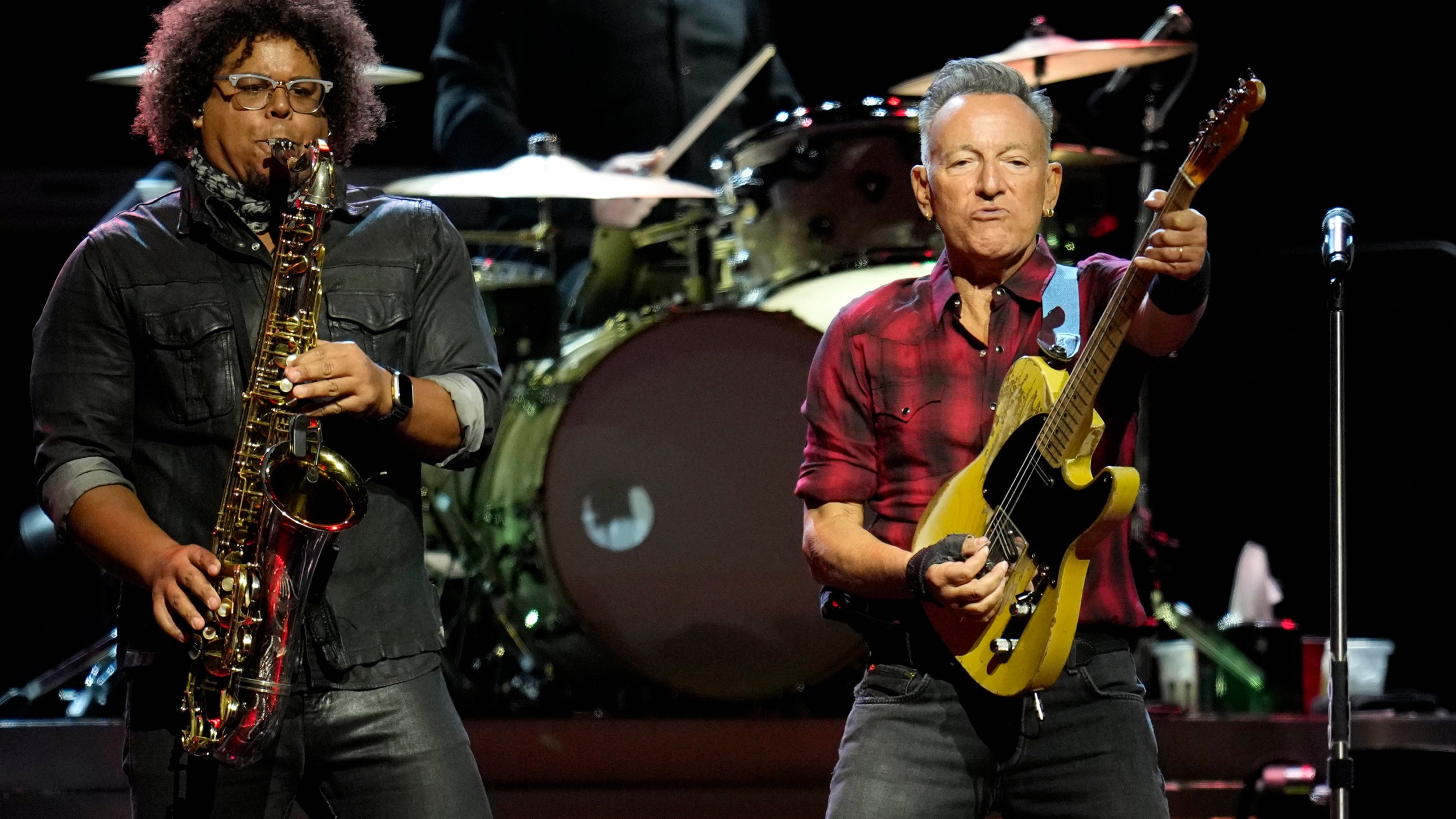 Bruce Springsteen, right, plays his guitar as Jake Clemons plays saxophone on stage during a concert of Bruce Springsteen and The E Street Band World Tour 2024 performance Tuesday, March 19, 2024, in Phoenix. (AP Photo/Ross D. Franklin)