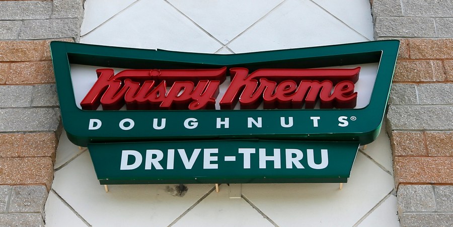 FILE - A Krispy Kreme Doughnuts sign is shown on Aug. 11, 2017, in Miami. Krispy Kreme stock jumped Tuesday, March 26, 2024, after it announced a deal where McDonald’s restaurants will sell its doughnuts across the country. (AP Photo/Alan Diaz, File)