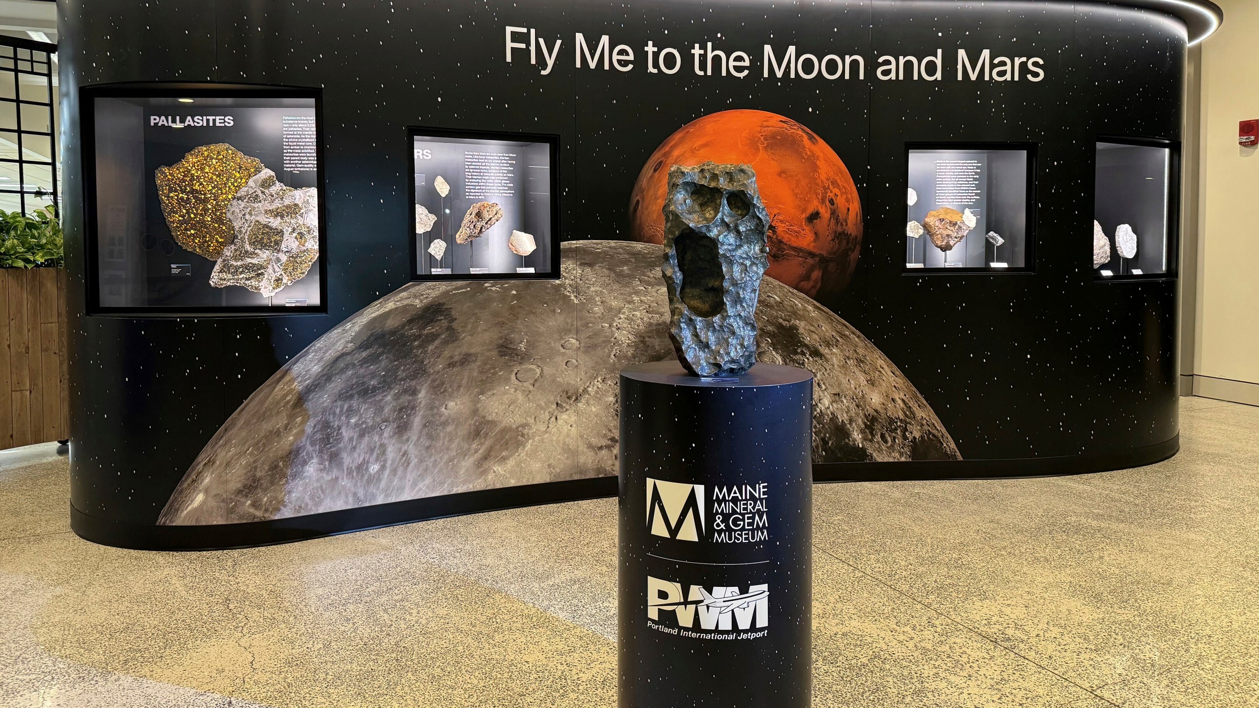 This March 20, 2024, photo by Darryl Pitt shows an installation at Portland International Jetport in Maine that features a large piece of the moon. The installation, which went live Tuesday, March 26, 2024, features the second largest piece of the moon on Earth. (Darryl Pitt via AP)