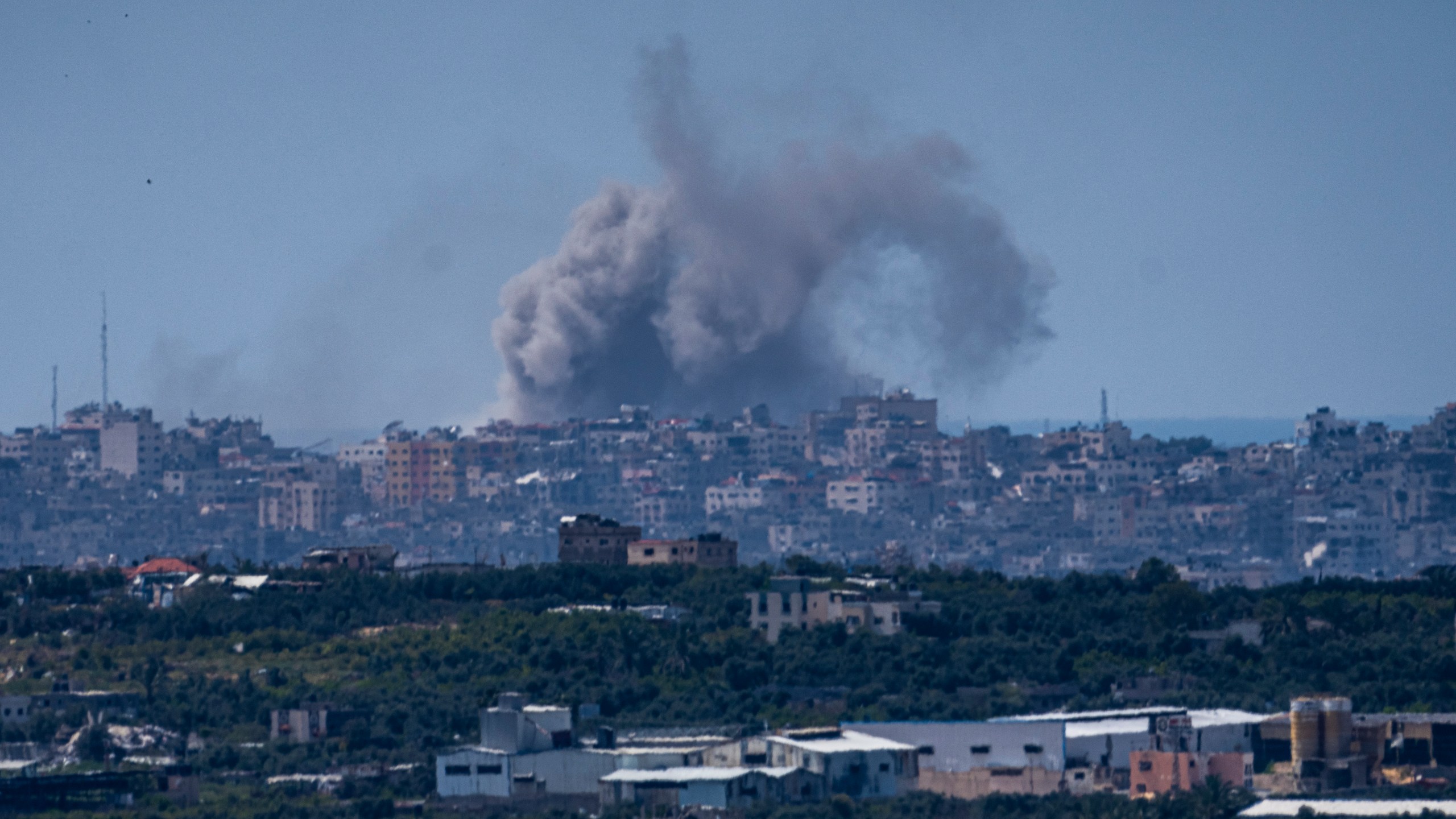 An explosion rises in the northern Gaza Strip, as seen from southern Israel, Tuesday, March 26, 2024. (AP Photo/Ariel Schalit)