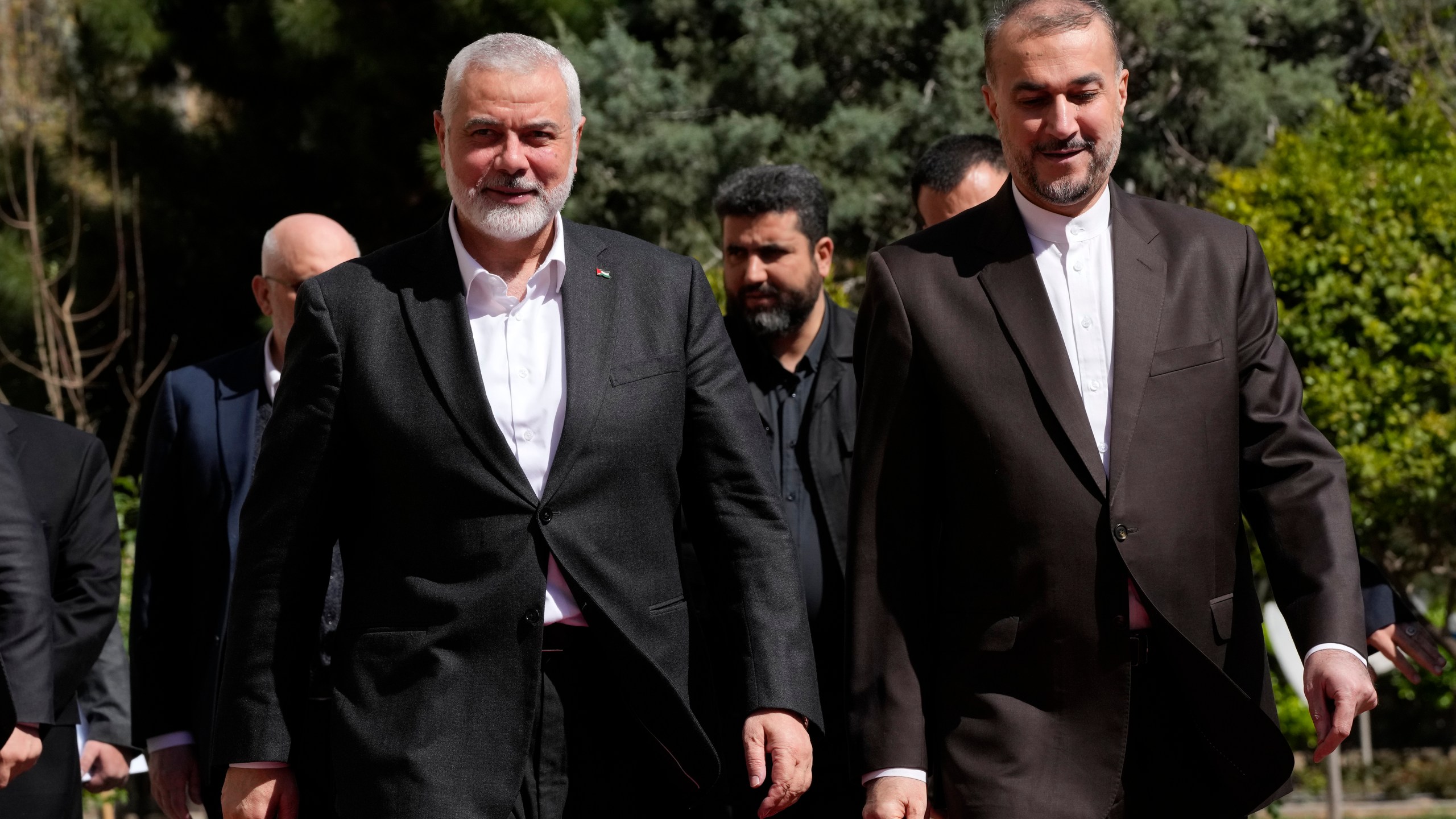 Hamas chief Ismail Haniyeh, left, is welcomed by Iranian Foreign Minister Hossein Amirabdollahian for their meeting in Tehran, Iran, Tuesday, March 26, 2024. (AP Photo/Vahid Salemi)