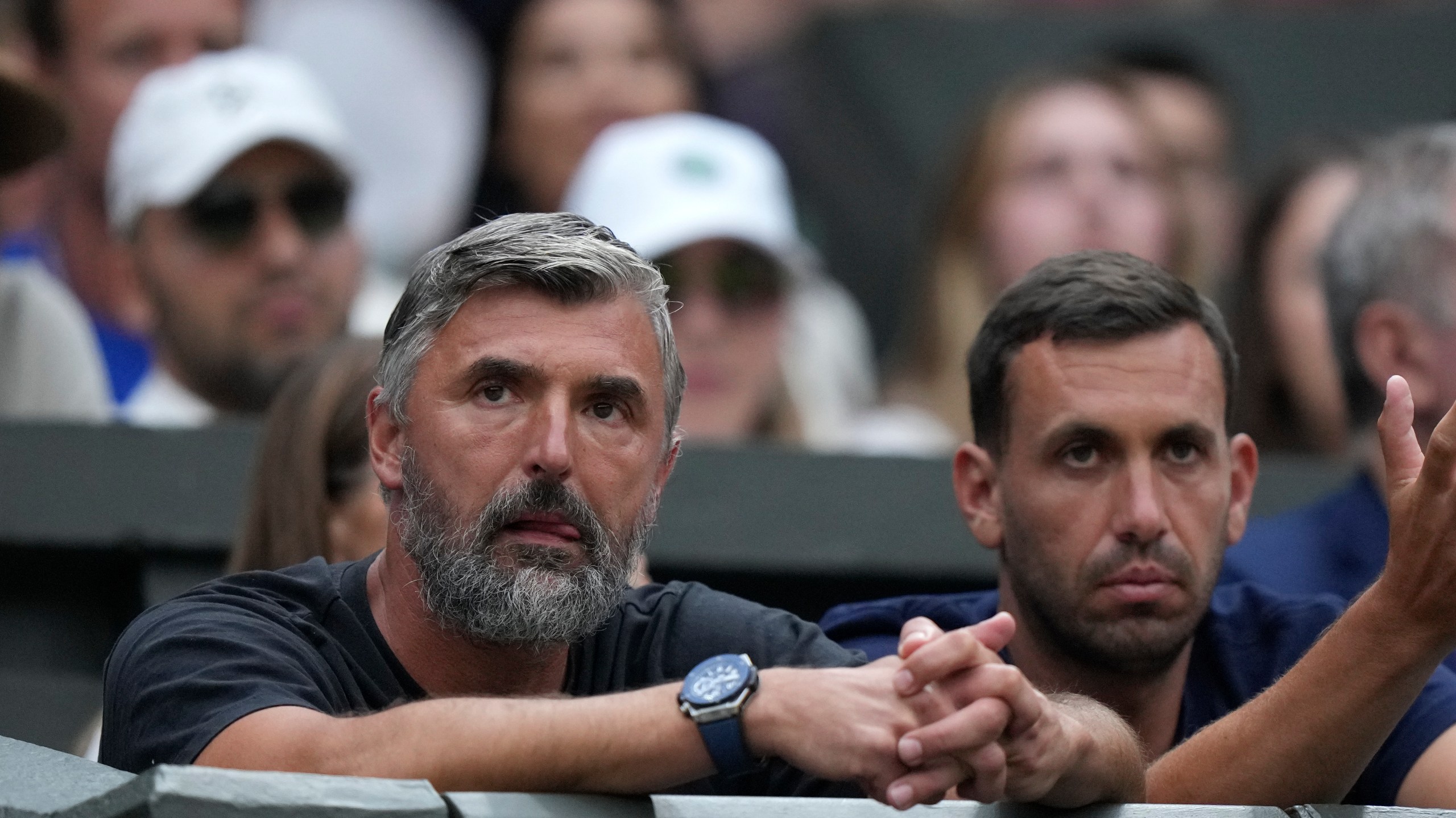 FILE - Goran Ivanisevic, left, a former tennis player and coach of Serbia's Novak Djokovic, watches as he plays Switzerland's Stan Wawrinka in a men's singles match on day five of the Wimbledon tennis championships in London, Friday, July 7, 2023. Djokovic has split with coach Goran Ivanisevic, ending their association that began in 2018 and included 12 Grand Slam titles for the Serbian tennis player, Djokovic wrote in a post on Instagram published Wednesday, March 27, 2024. (AP Photo/Alberto Pezzali, File)