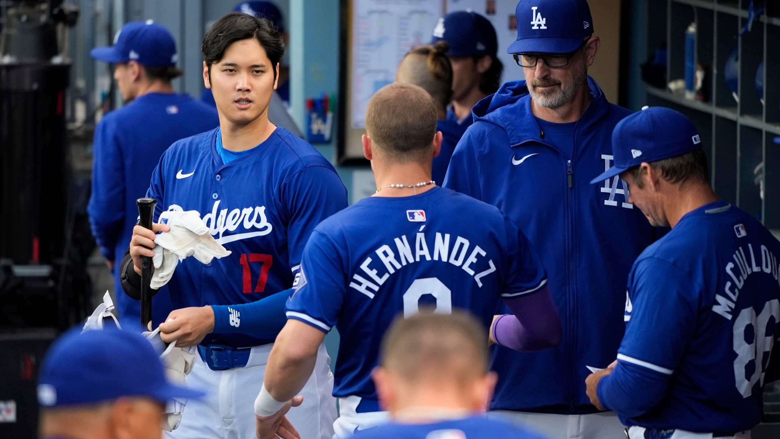 Los Angeles Dodgers' Shohei Ohtani (17) walks across the dugout during the first inning of a spring training baseball game against the Los Angeles Angels Monday, March 25, 2024, in Los Angeles. (AP Photo/Jae C. Hong)