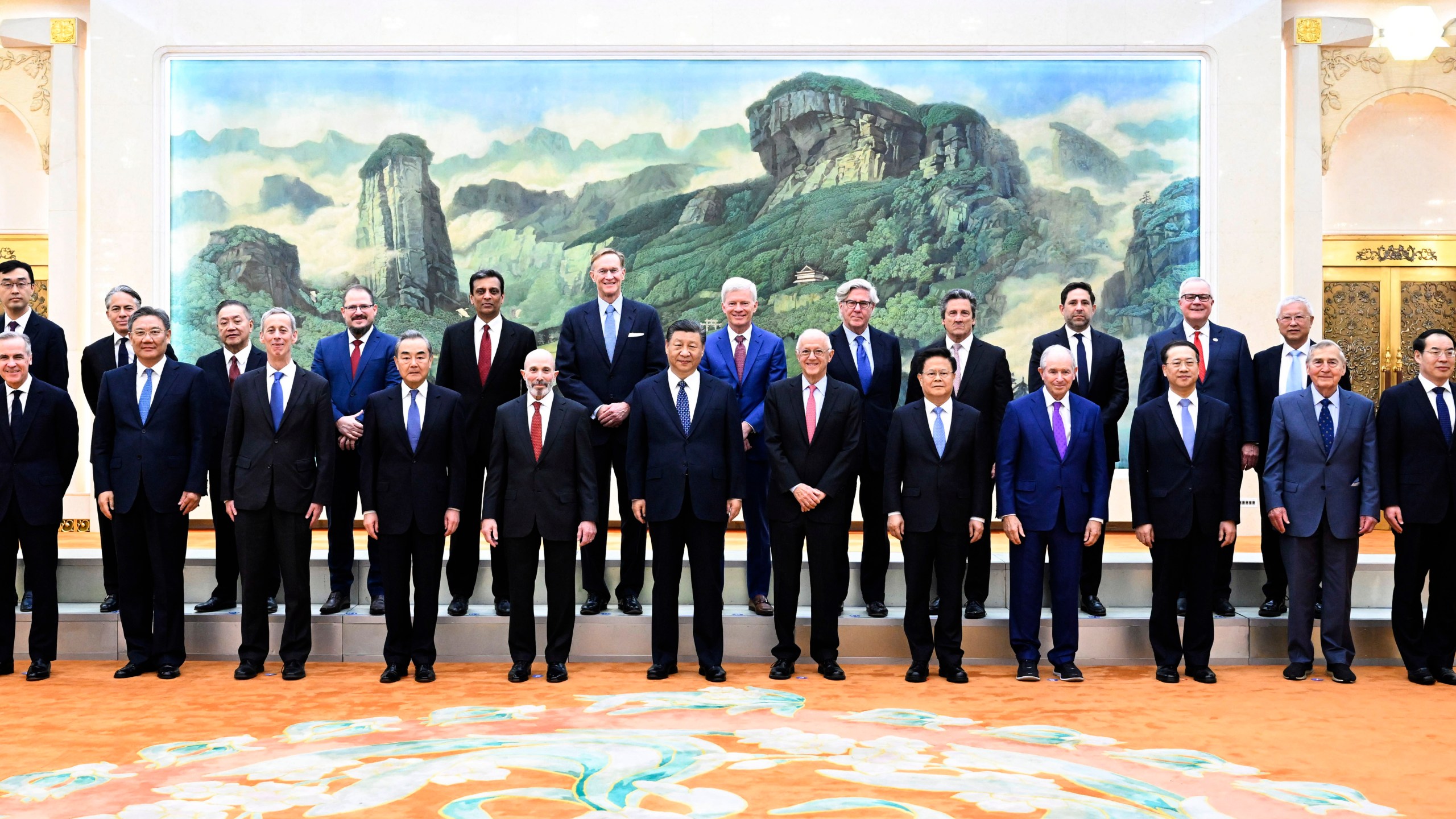 In this photo released by Xinhua News Agency, Chinese President Xi Jinping, center, poses for photos with representatives from American business, strategic and academic communities at the Great Hall of the People in Beijing, March 27, 2024. (Shen Hong/Xinhua via AP)