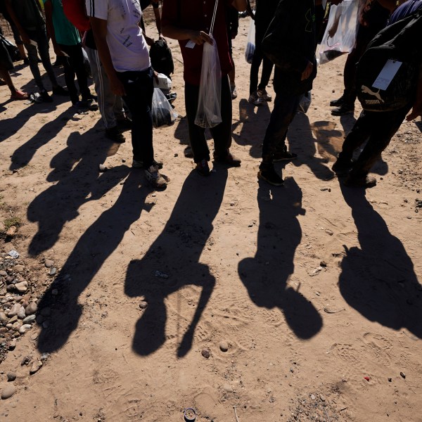 Migrants wait to be processed by Customs and Border Patrol on Oct. 19, 2023 in Eagle Pass, Texas.