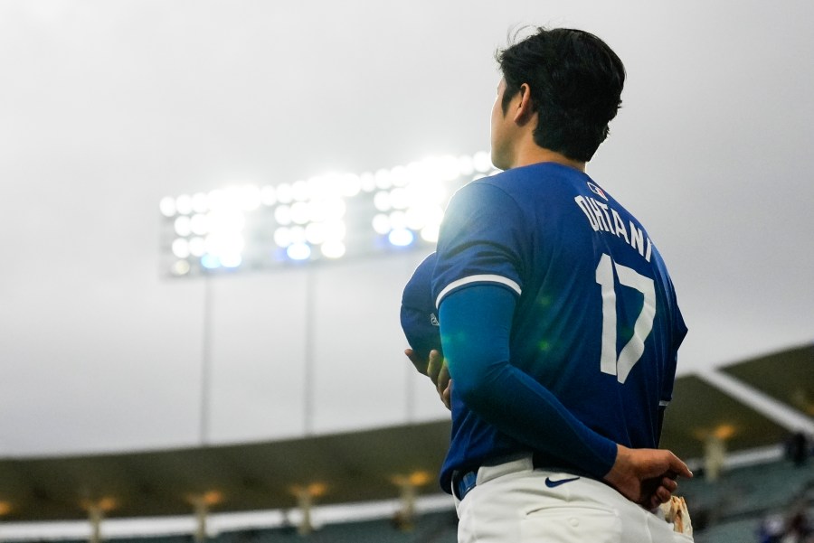 Los Angeles Dodgers designated hitter Shohei Ohtani (17) stands as the national anthem plays before a spring training baseball game against the Los Angeles Angels in Los Angeles, Sunday, March 24, 2024. (AP Photo/Ashley Landis)