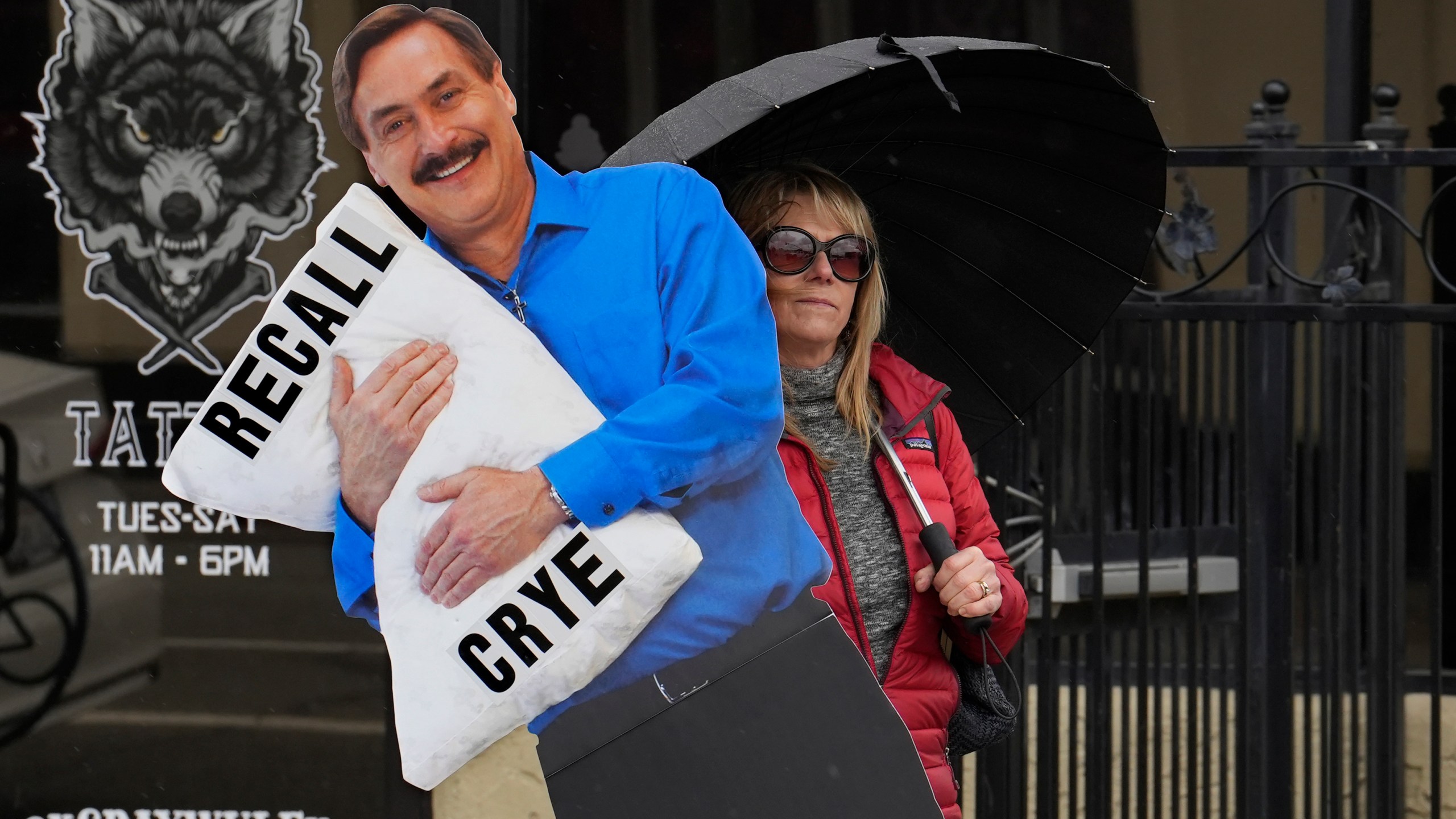 Stacy Oliver holds display of Mike Lindell, the controversial CEO of My Pillow who has advocated falsehoods about the 2020 presidential election, during a rally in Redding, Calif., on Tuesday, Feb. 20, 2024. Oliver supports recalling Shasta County Supervisor Kevin Crye from office. Crye is one of the board members who voted to get rid of the county's ballot-counting machines in favor of counting ballots by hand. Crye had previously met with Lindell, an action that angered some voters. (AP Photo/Rich Pedroncelli)