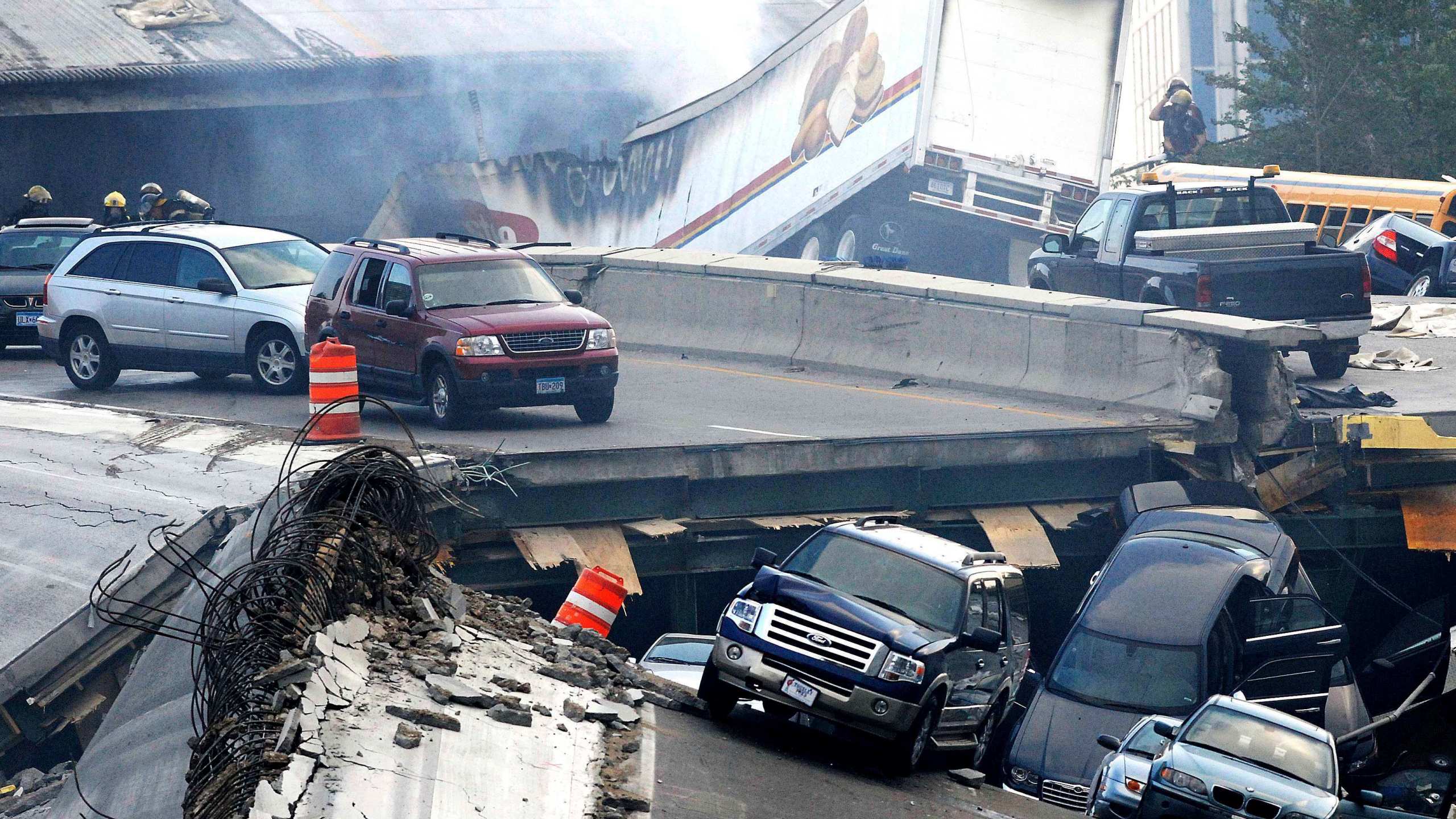 FILE - In this Wednesday, Aug. 1, 2007 picture, vehicles are scattered along the broken remains of the Interstate 35W bridge, which stretches between Minneapolis and St. Paul, after it collapsed into the Mississippi River during evening rush hour. The collapse of the Francis Scott Key Bridge in Baltimore following a ship strike on March 26, 2024 brought back jarring memories of their own ordeals to people who survived previous bridge collapses. (Stacy Bengs/The Minnesota Daily via AP)