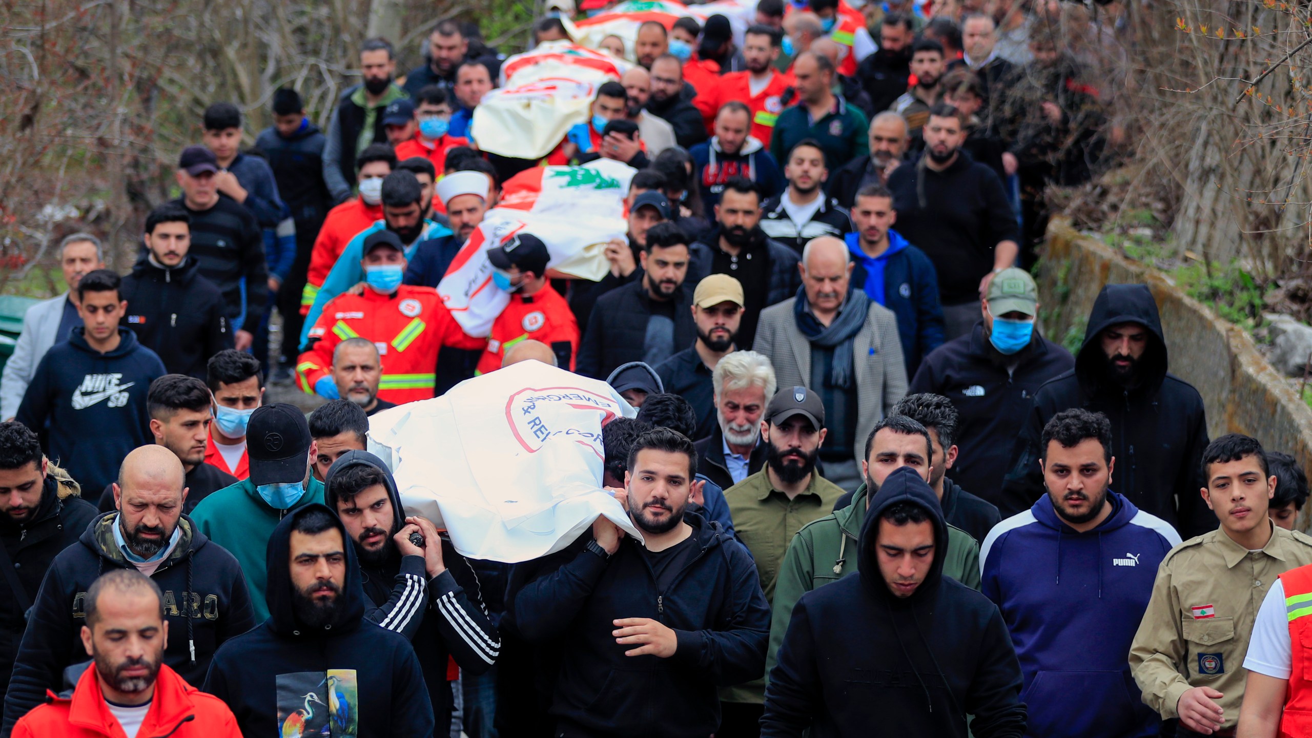 People carry the coffins of paramedics who were killed in an Israeli airstrike, during a funeral procession in Hebbariye village, south Lebanon, Wednesday, March 27, 2024. The Israeli airstrike on a paramedic center linked to a Lebanese Sunni Muslim group killed several people. The strike was one of the deadliest single attacks since violence erupted along the Lebanon-Israel border more than five months ago. (AP Photo/Mohammed Zaatari)