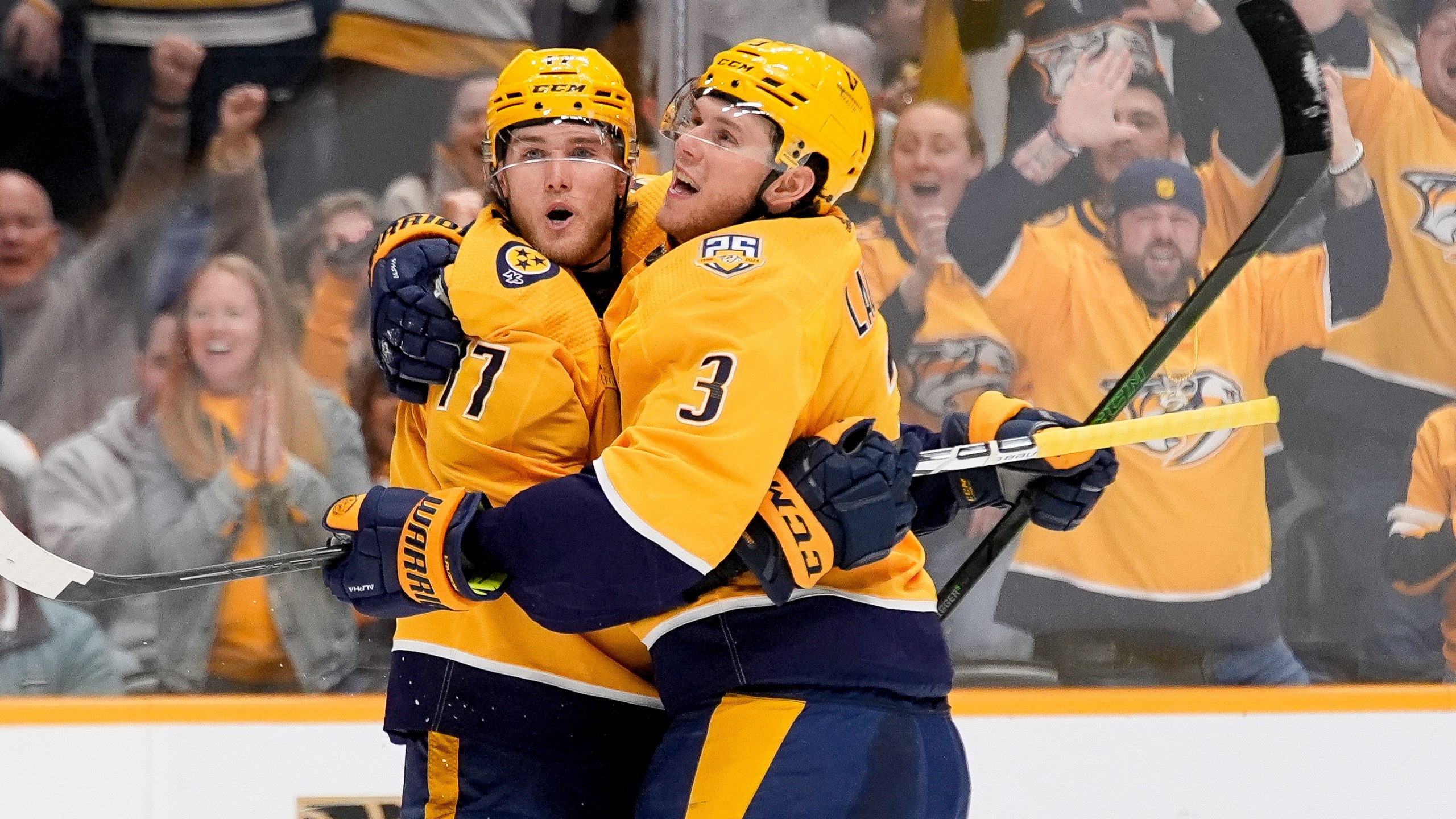Nashville Predators center Mark Jankowski (17) celebrates his goal with defenseman Jeremy Lauzon (3) during the second period of an NHL hockey game against the Vegas Golden Knights, Tuesday, March 26, 2024, in Nashville, Tenn. (AP Photo/George Walker IV)