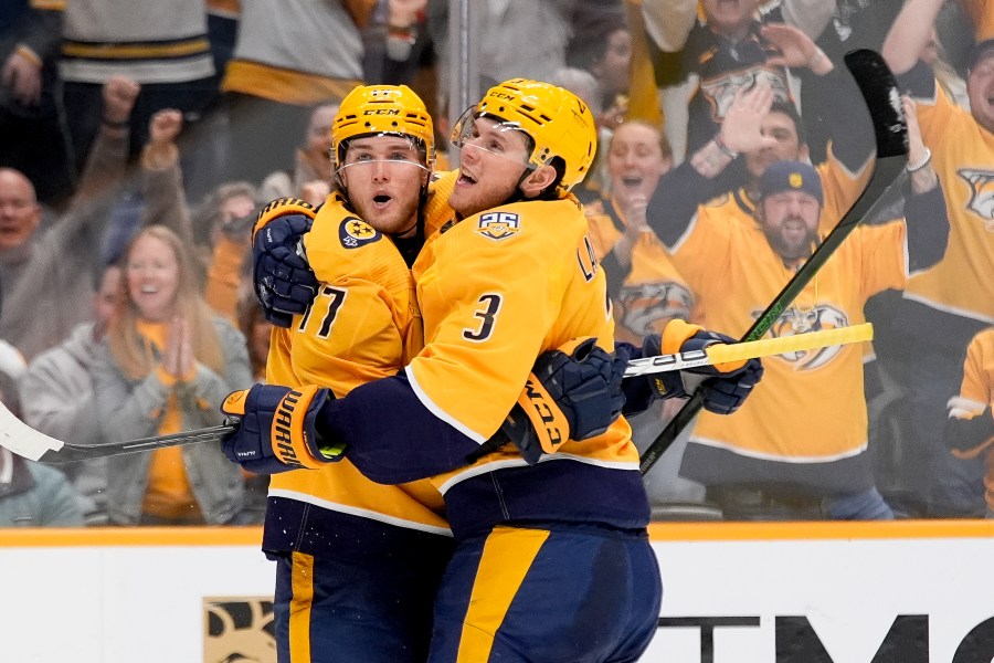 Nashville Predators center Mark Jankowski (17) celebrates his goal with defenseman Jeremy Lauzon (3) during the second period of an NHL hockey game against the Vegas Golden Knights, Tuesday, March 26, 2024, in Nashville, Tenn. (AP Photo/George Walker IV)