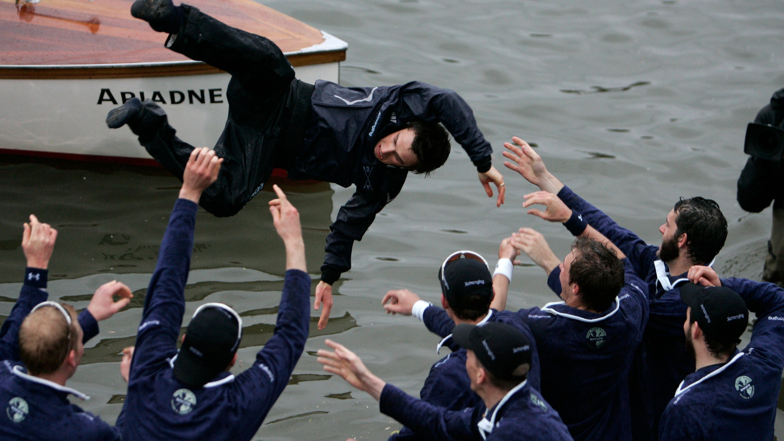 FILE - Members of the Oxford University rowing team throw their cox Nicholas Brodie, centre, into the river after beating Cambridge University, at the 154th annual Boat Race on the River Thames, London, Saturday, March 29, 2008. Jumping into London’s River Thames has been the customary celebration for members of the winning crew in the annual Boat Race between storied English universities Oxford and Cambridge. Now researchers say it comes with a health warning. (AP Photo/Lefteris Pitarakis, File)