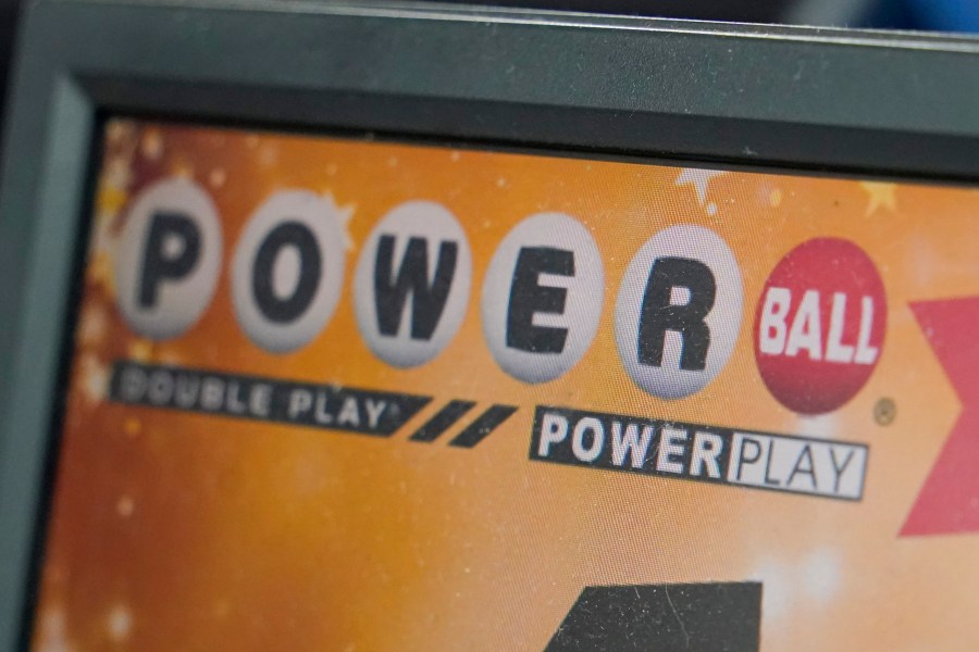 FILE - A display panel advertises tickets for a Powerball drawing at a convenience store, Nov. 7, 2022, in Renfrew, Pa. There is an $865 million Powerball jackpot up for grabs Wednesday night, March 27, 2024. (AP Photo/Keith Srakocic, File)