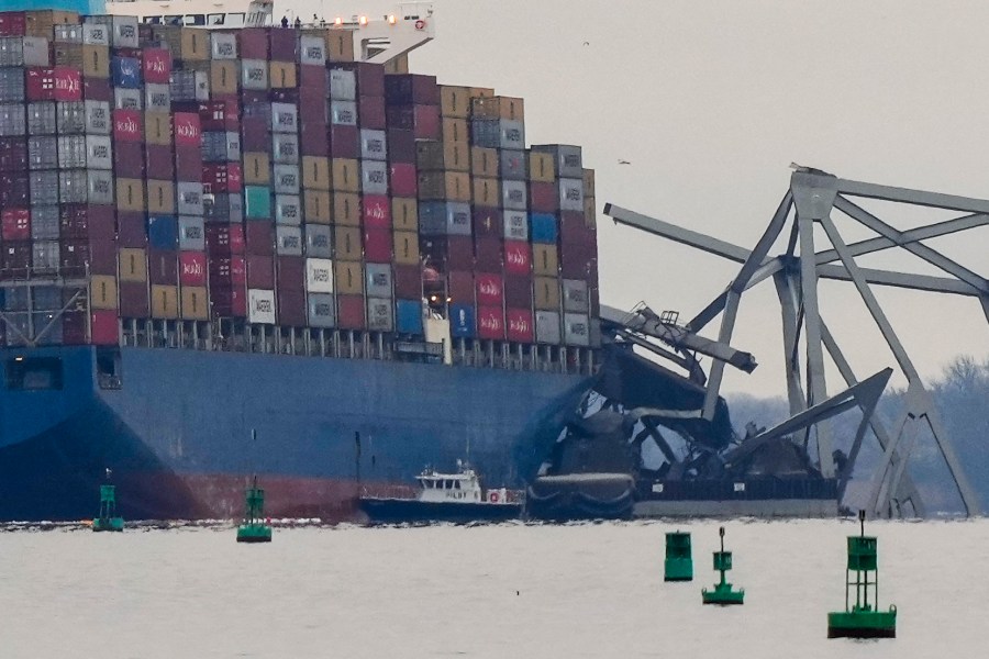 A container ship rests against wreckage of the Francis Scott Key Bridge on Wednesday, March 27, 2024, in Baltimore. The ship rammed into the major bridge early Tuesday, causing it to collapse in a matter of seconds and creating a terrifying scene as several vehicles plunged into the chilly river below. (AP Photo/Matt Rourke)