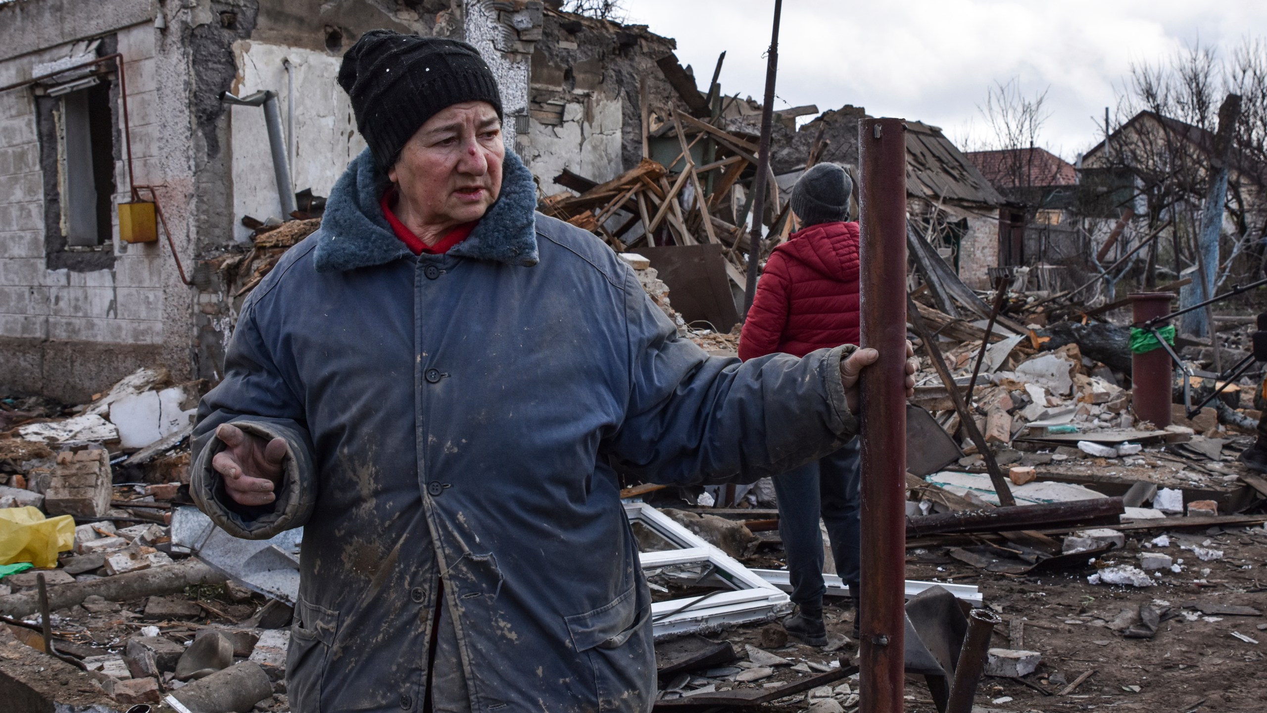 Inna, 71, stands outside of her house which was destroyed by a Russian drone attack in a residential neighbourhood, in Zaporizhzhia, Ukraine, on Thursday, March 28, 2024. (AP Photo/Andriy Andriyenko)