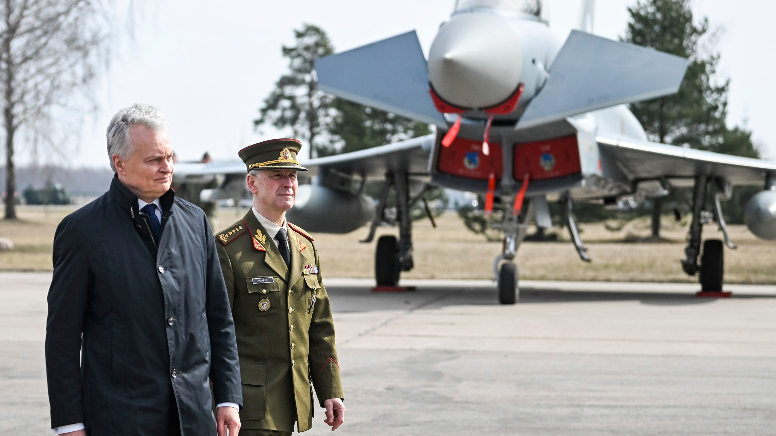 In this photo provided by Lithuanian Ministry of National Defense, Lithuania's Presiodent Gitanas Nauseda , left, and Chief of Defence of Lithuania Gen Valdemaras Rupsys arrive for celebration Lithuania's NATO membership 20th anniversary at the Siauliai airbase, some 230 km (144 miles) east of the capital Vilnius, Lithuania, Thursday, March 28, 2024. (Alfredas Pliadis/Lithuanian Ministry of National Defense via AP)