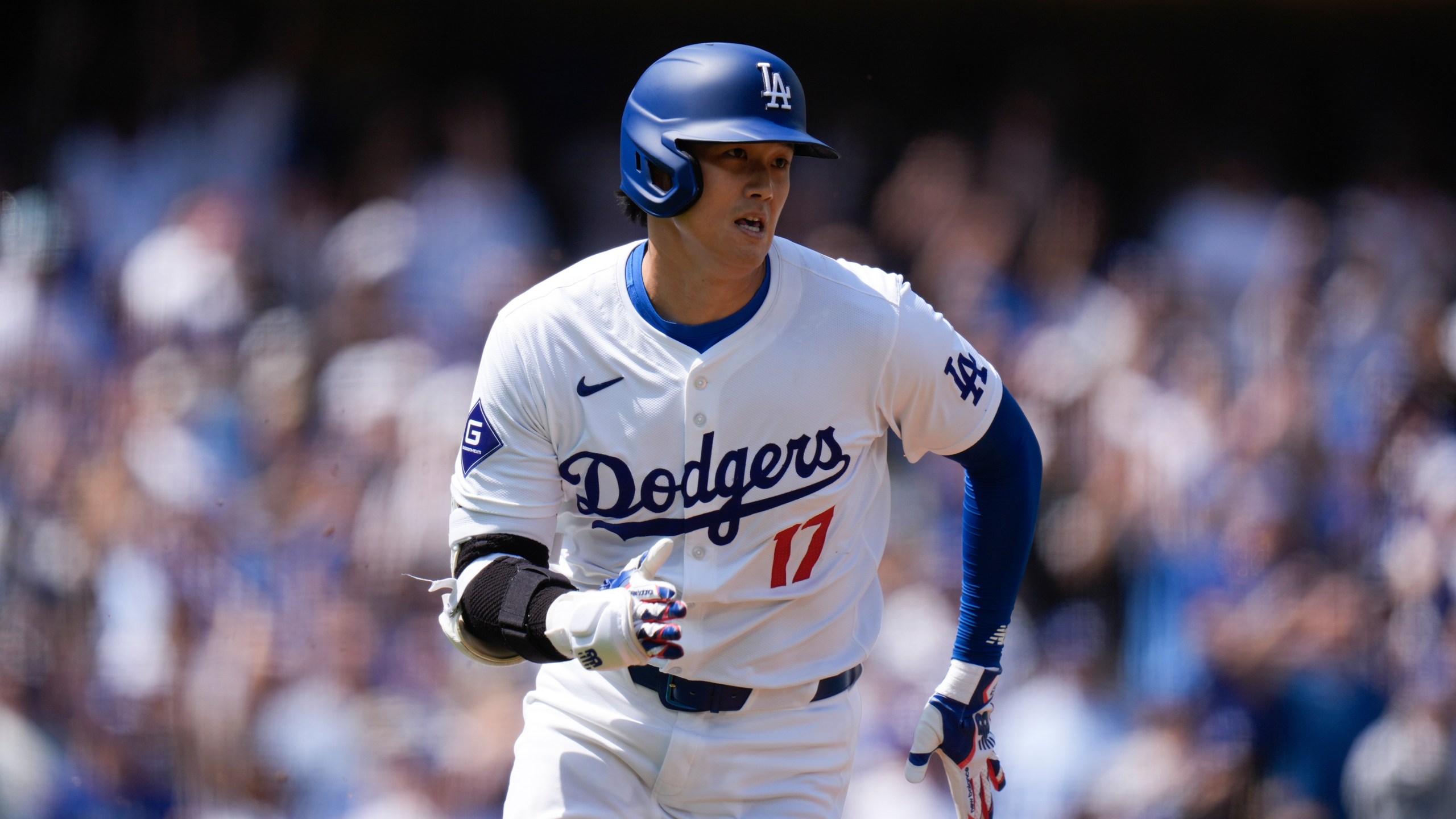 Los Angeles Dodgers' Shohei Ohtani runs to first base after hitting a double against the St. Louis Cardinals during the first inning of a baseball game Thursday, March 28, 2024, in Los Angeles. (AP Photo/Jae C. Hong)