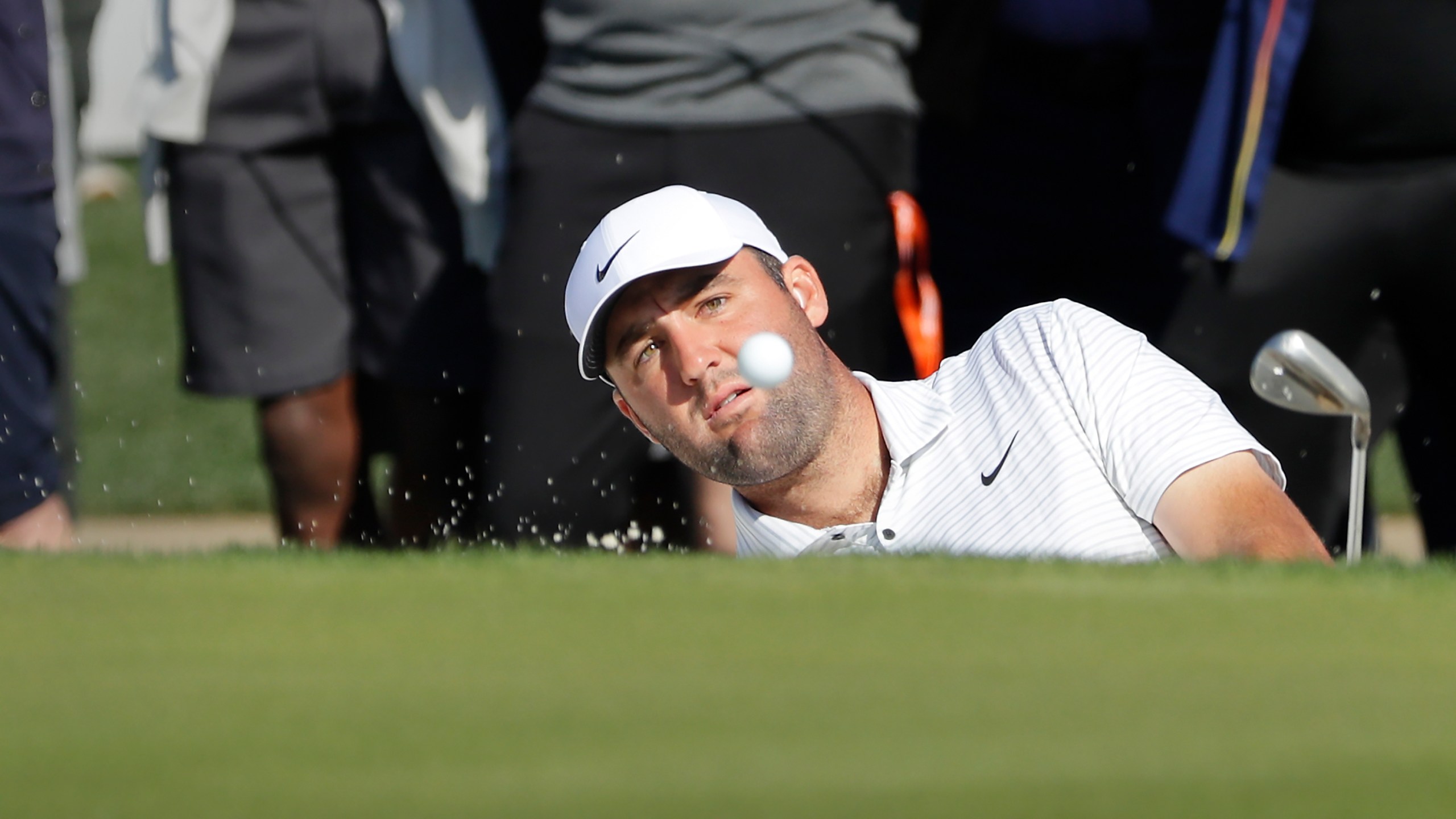 Scottie Scheffler hits out of the bunker on the 18th green during the first round of the Houston Open golf tournament Thursday, March, 28, 2024, in Houston. (AP Photo/Michael Wyke)