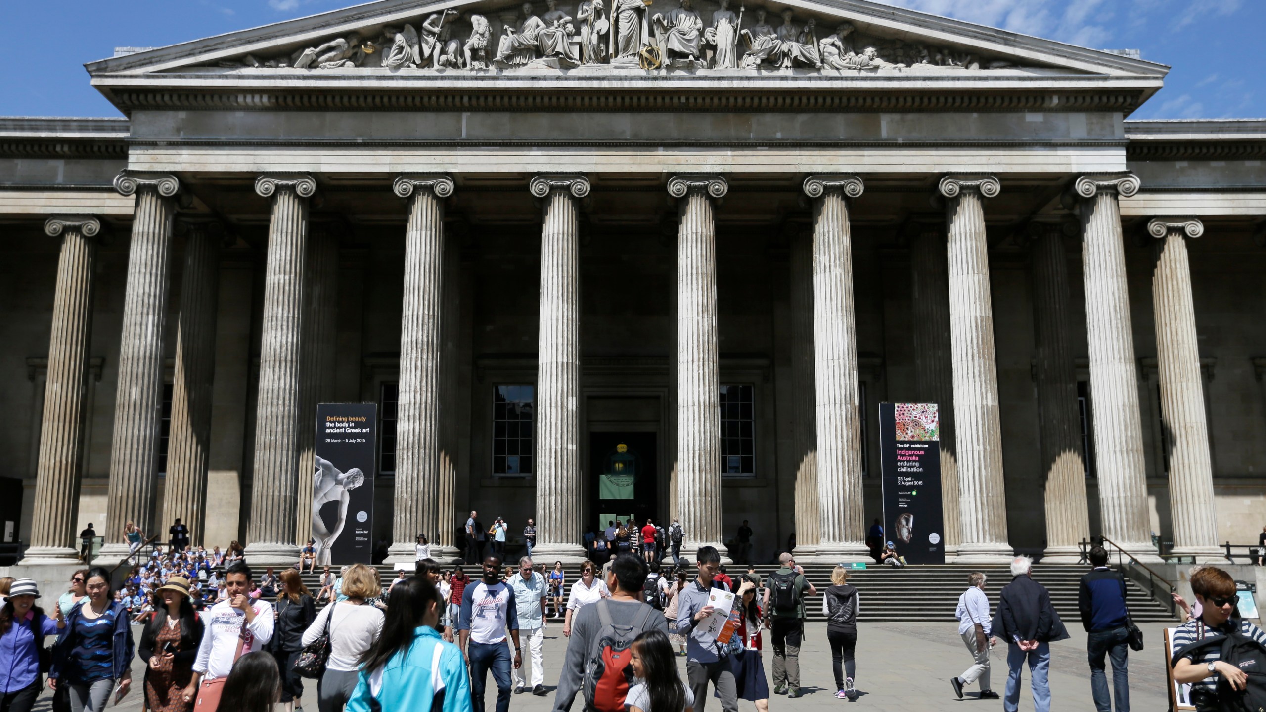 FILE - Visitors walk outside the British Museum in Bloomsbury, London, Friday, June 26, 2015. The British Museum is suing a former curator alleged to have stolen almost 2,000 artifacts from its collections and offered them for sale online. Peter Higgs was fired in July 2023 after more than 1,800 items were discovered to be missing. (AP Photo/Tim Ireland, File)