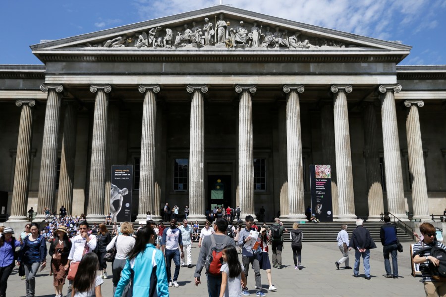 FILE - Visitors walk outside the British Museum in Bloomsbury, London, Friday, June 26, 2015. The British Museum is suing a former curator alleged to have stolen almost 2,000 artifacts from its collections and offered them for sale online. Peter Higgs was fired in July 2023 after more than 1,800 items were discovered to be missing. (AP Photo/Tim Ireland, File)