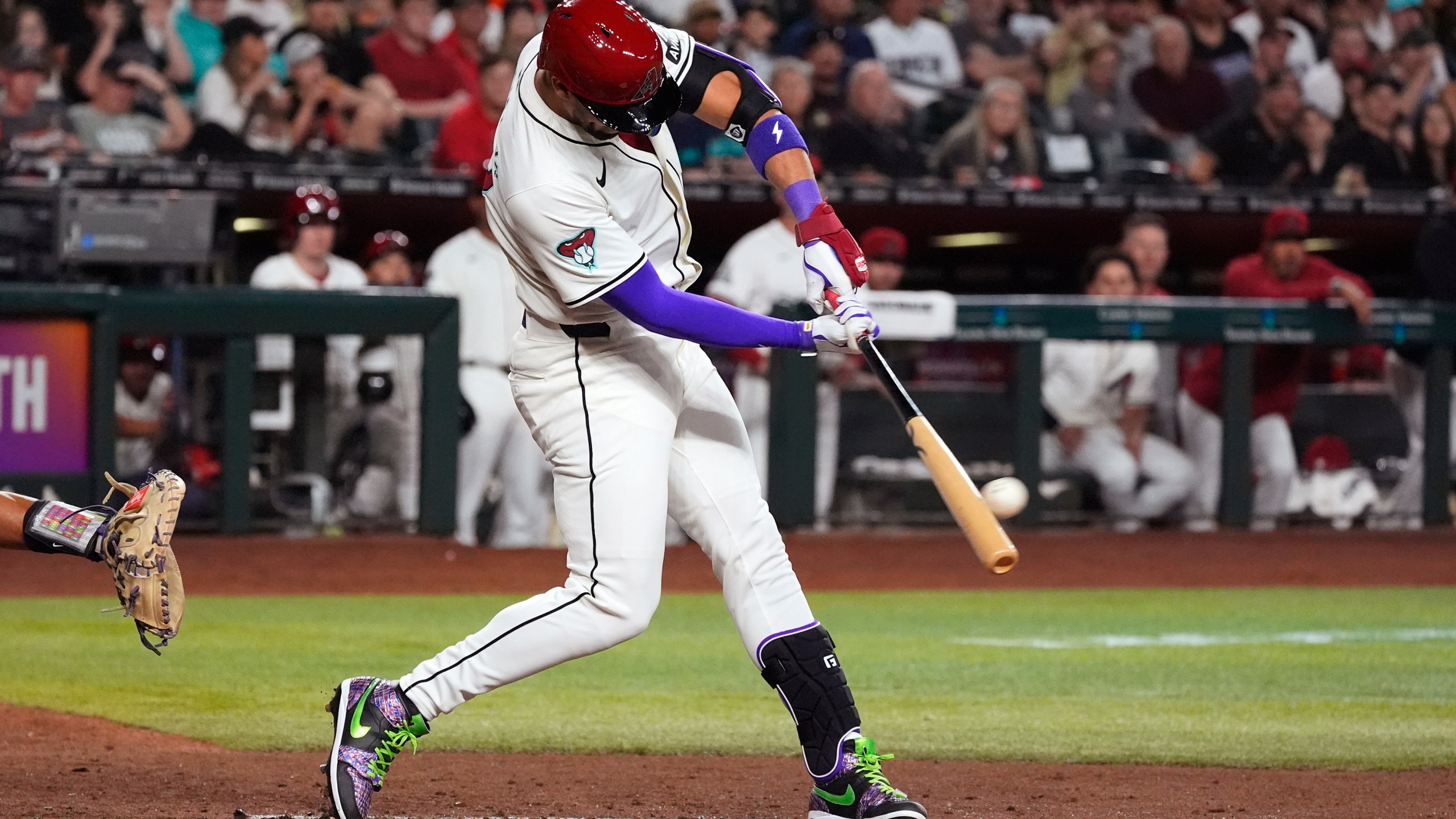 Arizona Diamondbacks' Lourdes Gurriel Jr. connects for a run-scoring single against the Colorado Rockies during the third inning of a baseball game Thursday, March 28, 2024, in Phoenix. (AP Photo/Ross D. Franklin)