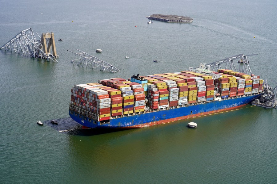 In this aerial image released by the Maryland National Guard, the cargo ship Dali is stuck under part of the structure of the Francis Scott Key Bridge after the ship hit the bridge, Tuesday, March 26, 2024, in Baltimore. (Maryland National Guard via AP)