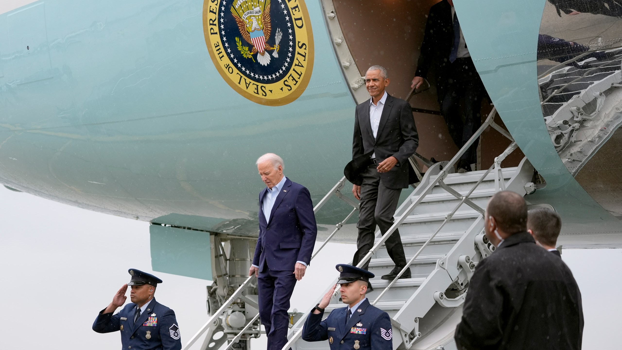 President Joe Biden, left, and former President Barack Obama exit Air Force One upon arriving at John F. Kennedy International Airport, Thursday, March 28, 2024, in New York. (AP Photo/Alex Brandon)