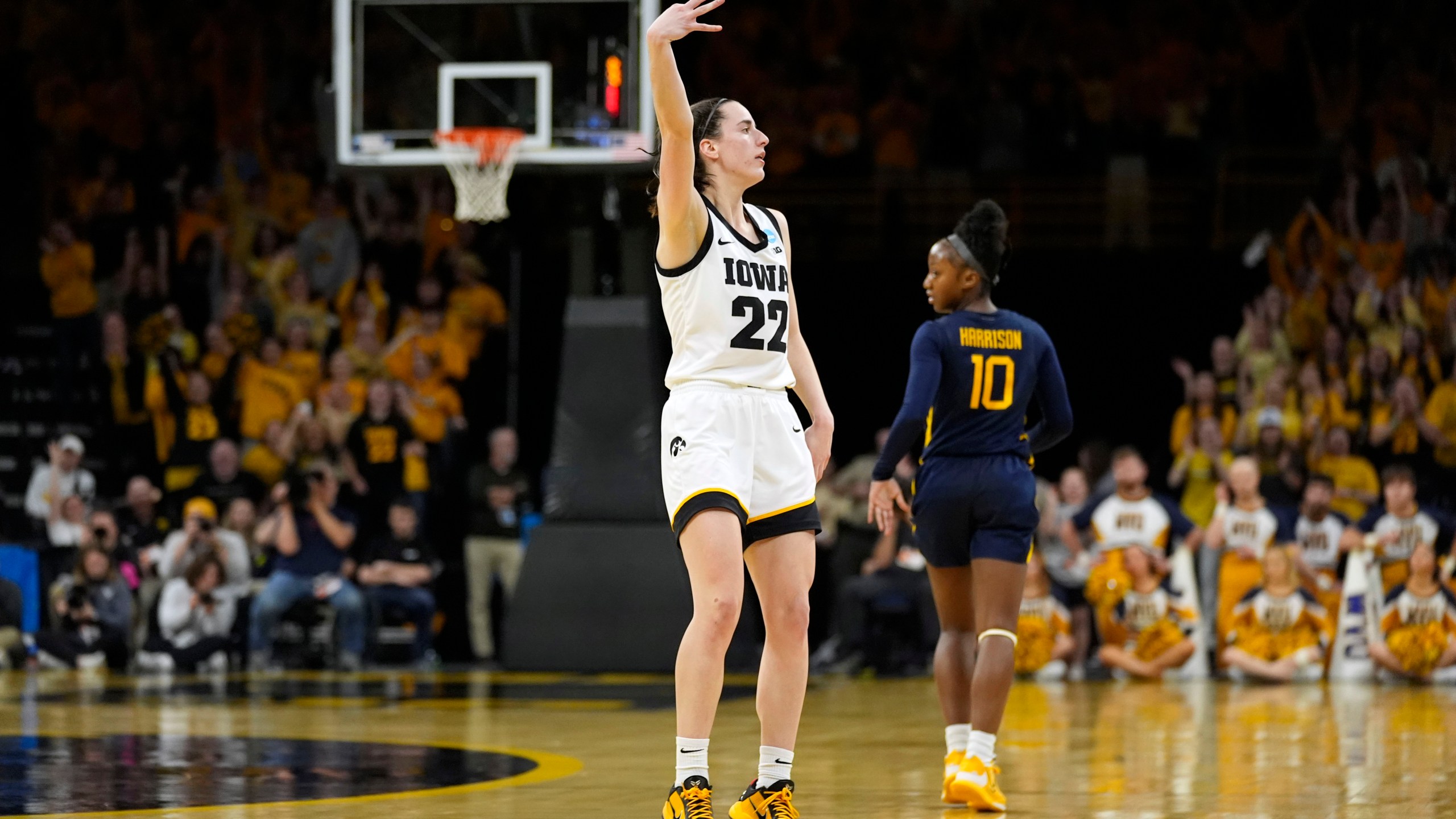Iowa guard Caitlin Clark (22) celebrates after making a three-point basket in the second half of a second-round college basketball game against West Virginia in the NCAA Tournament, Monday, March 25, 2024, in Iowa City, Iowa. (AP Photo/Charlie Neibergall)